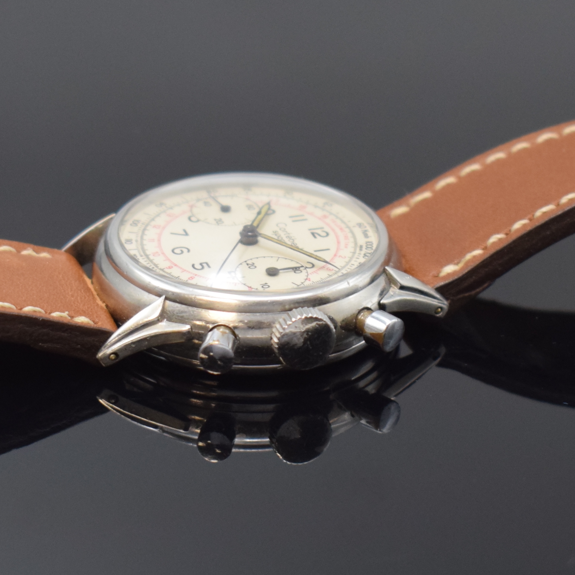 Detail b: CORTEBERT verschraubter Schaltradchronograph in Stahl, Schweiz um 1950, Handaufzug, 2- tlg. Geh., ausgefallene Bandanstöße, silb. Zifferbl. rest., ...