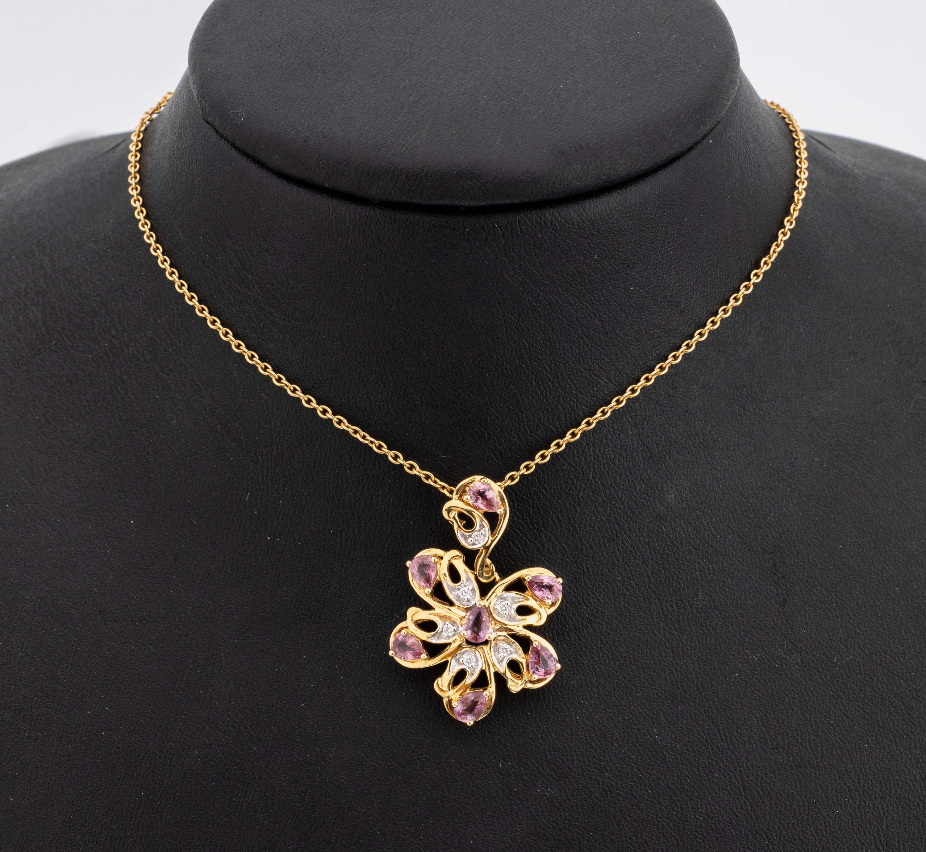 18 kt Gold Saphir-Brillant-Anhänger, GG 750/000, abstrakte Gestaltung, 7 facett. Pinksaphir-Tropfen zus. ca. 1.60 ct, 6 Brillanten in rhod. ...