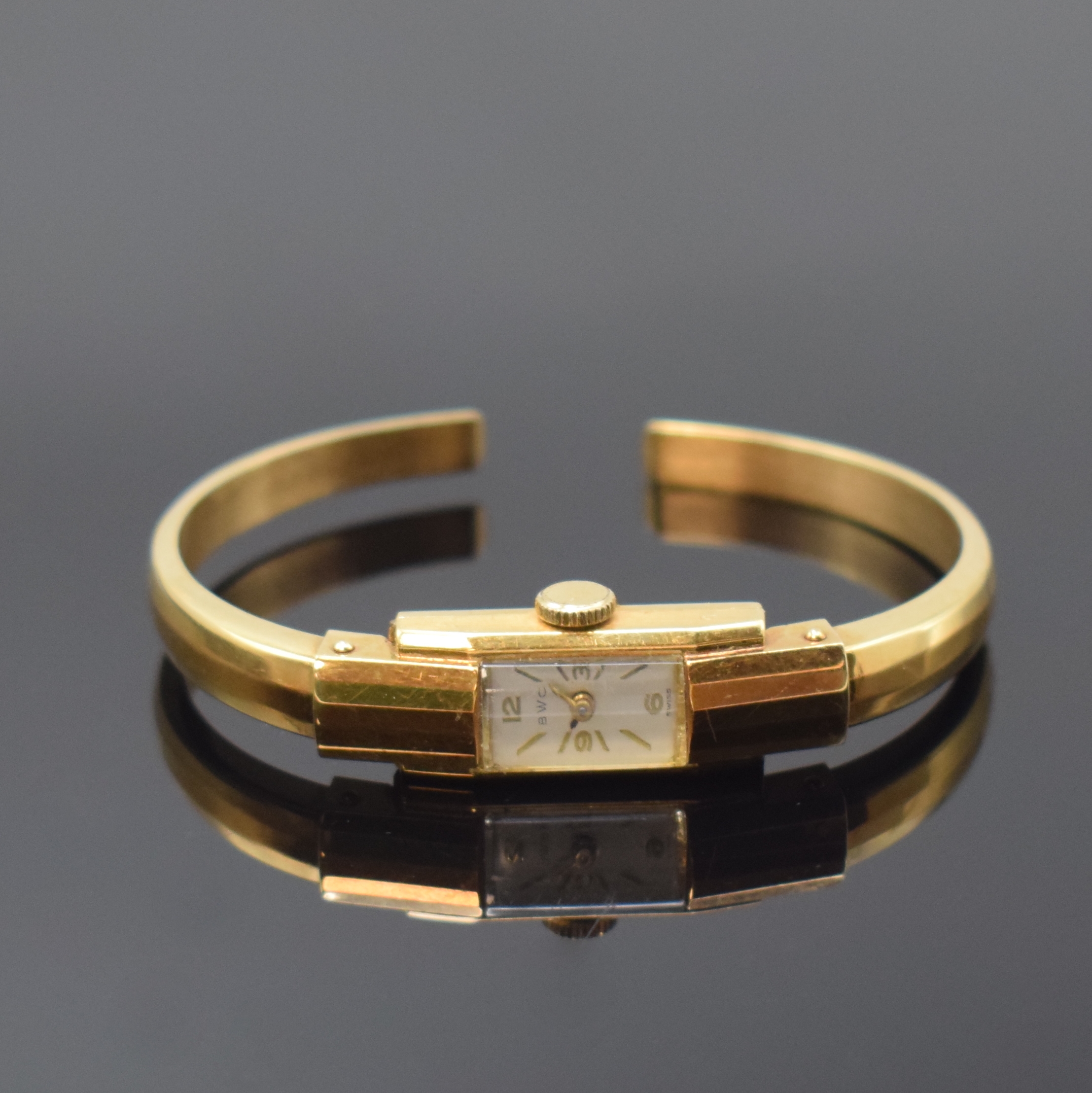 BWC Spangenuhr in GG 585/000, Schweiz um 1940, Handaufzug, Scharnierboden, silb. Zifferbl., gold. Std.-Ind. u. Zahlen, gold. Zeiger, geschw. Std.- ...