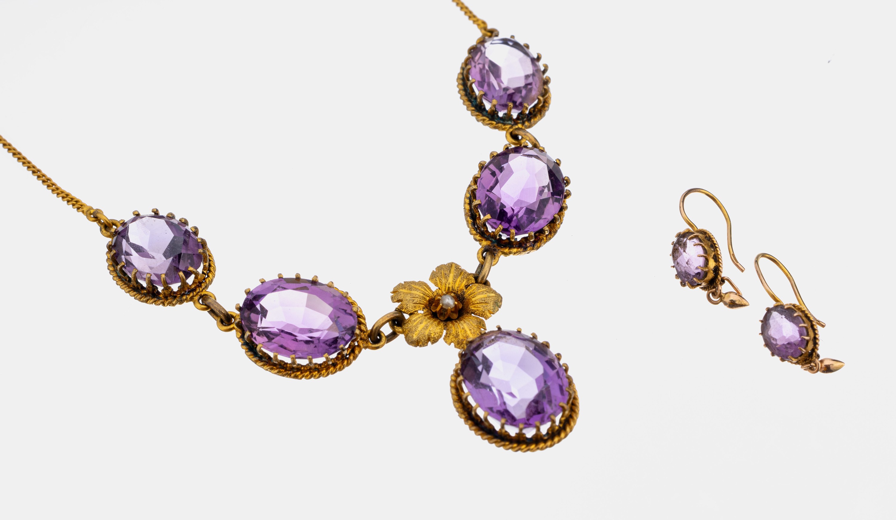 14 kt Gold Amethyst-Schmuckset, GG 585/000,best. aus: Collier mit 5 ovalfacett. Amethysten zus. ca. 43.50 ct, bewegl. Abhängung, mittig Blüte mit ...
