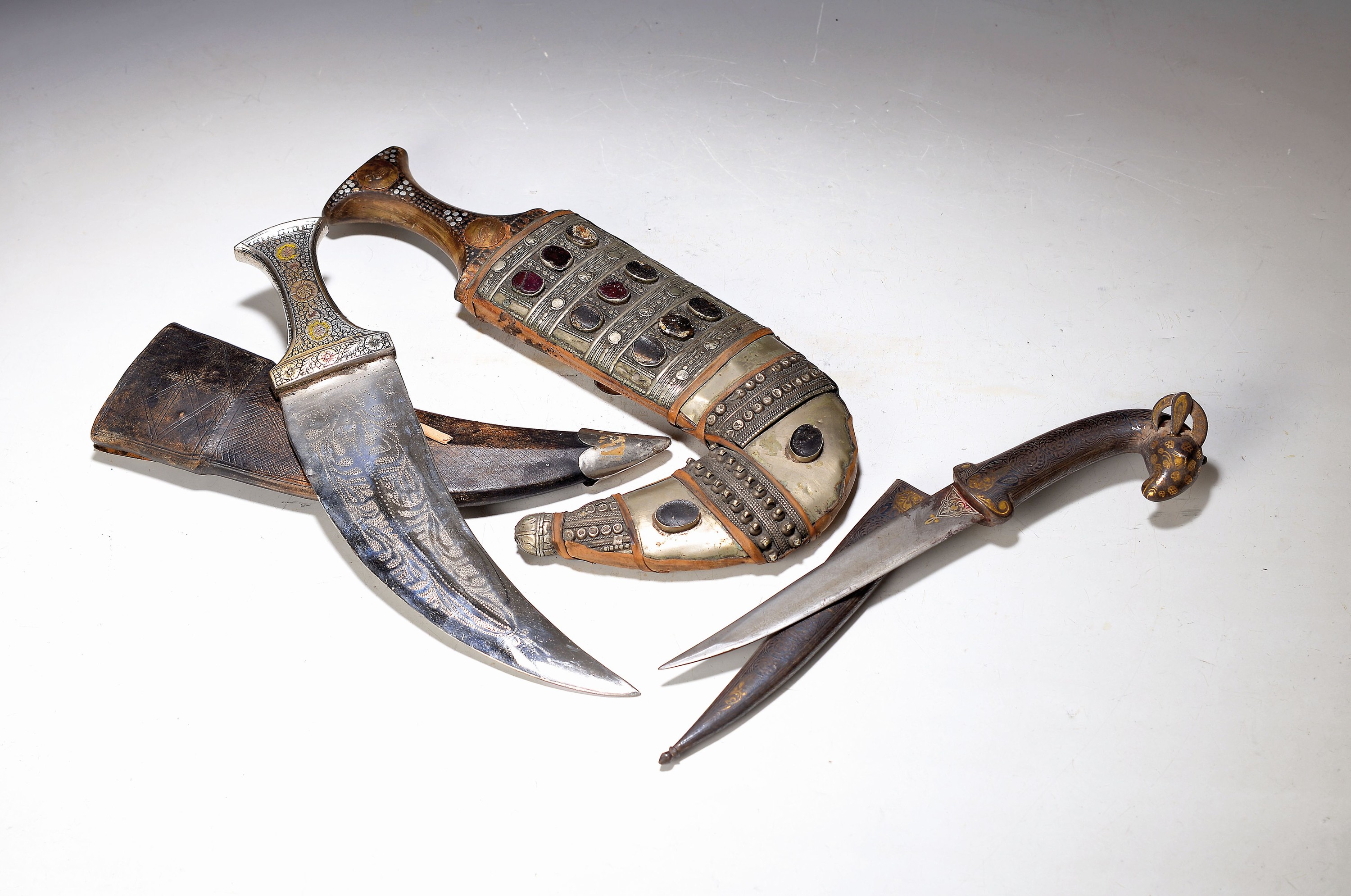 Zwei Dolche, arabisch, 2. Hälfte 20. Jh., 1 x Jambyia, mit Glascabochons besetzt, ein Stein fehlt, mit versilberter Auflage, , zweiter Dolch mit ...