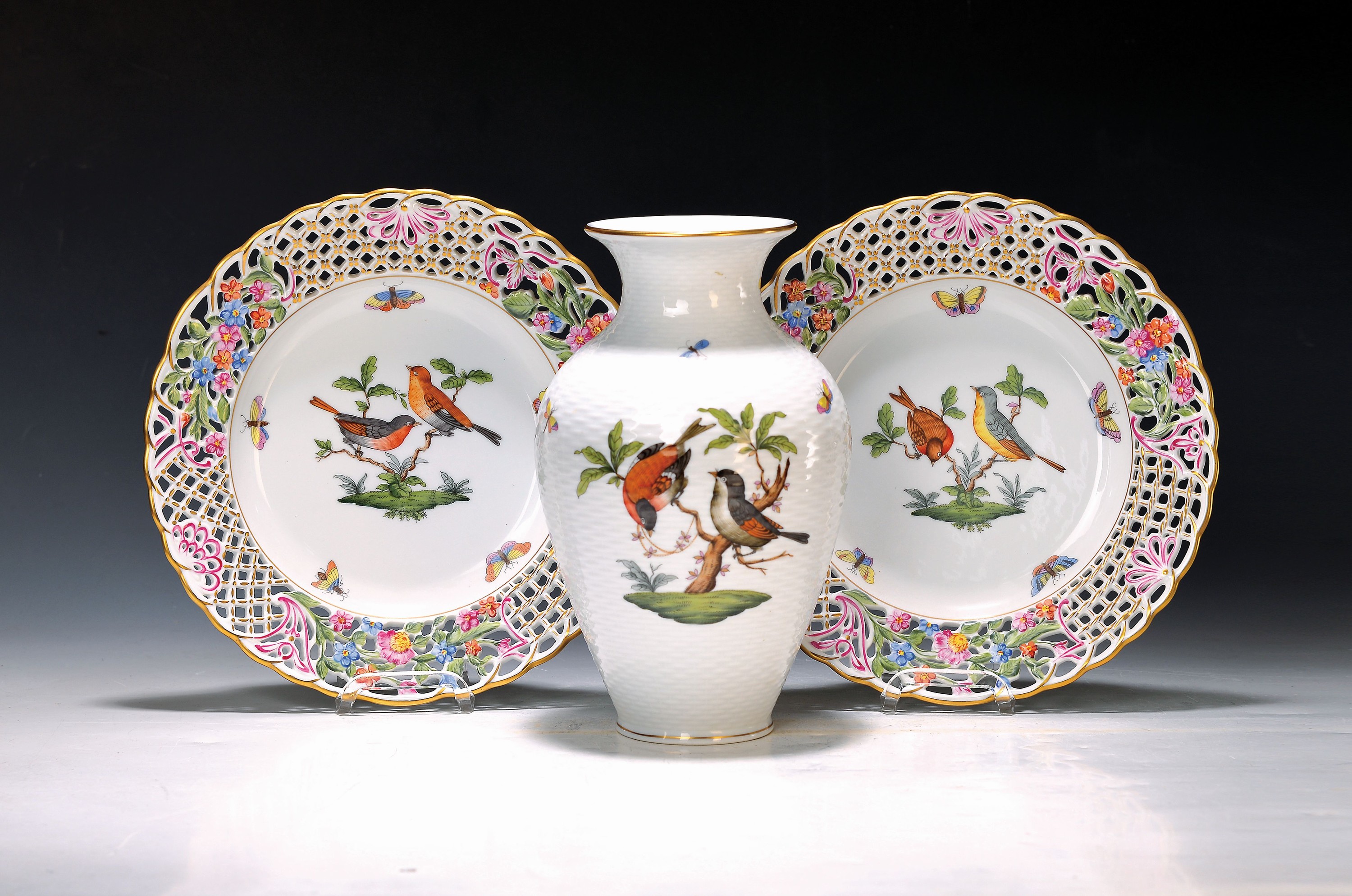 2 Teller und eine Vase, Herend, Ungarn, Dekor Victoria, Porzellan, handbemalt, Goldrand, 2 Teller mit Rand in Durchbrucharbeit, D. 24 cm; Vase mit ...