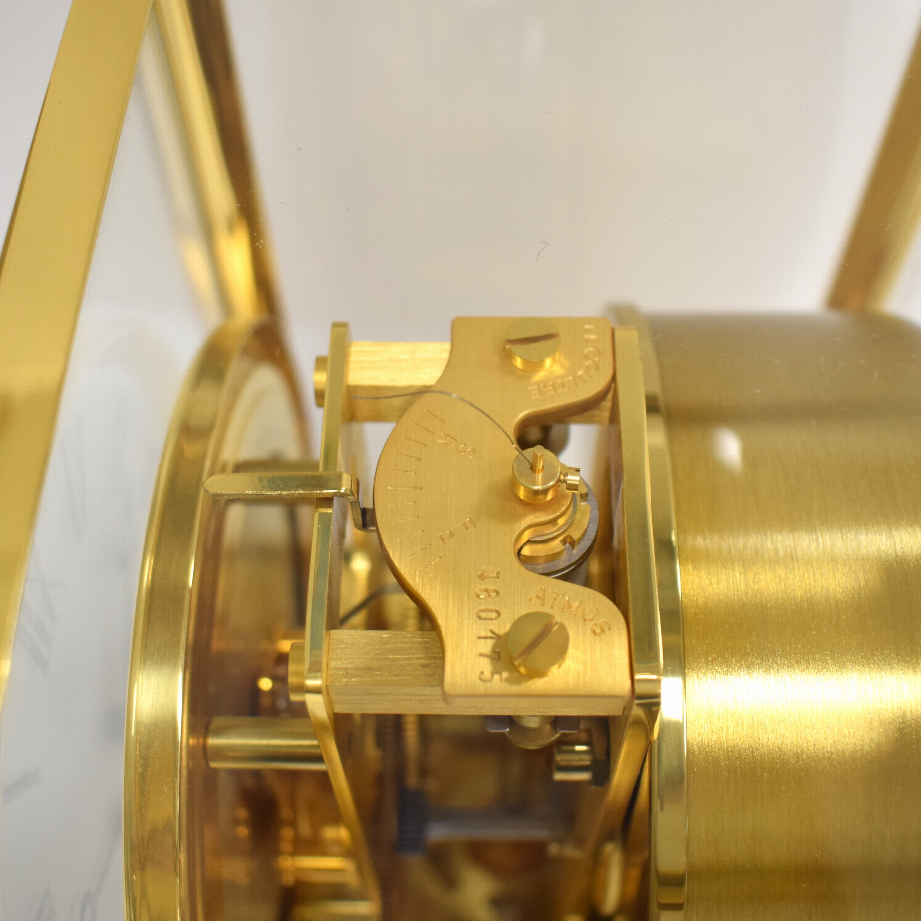 Detail e: Jaeger-LeCoultre Drehpendel-Tischuhr Atmos Classic, Schweiz um 1980, verg., 5-seitig vergl. Geh., nach vorn zu öffnen durch Glastür, weißes ...