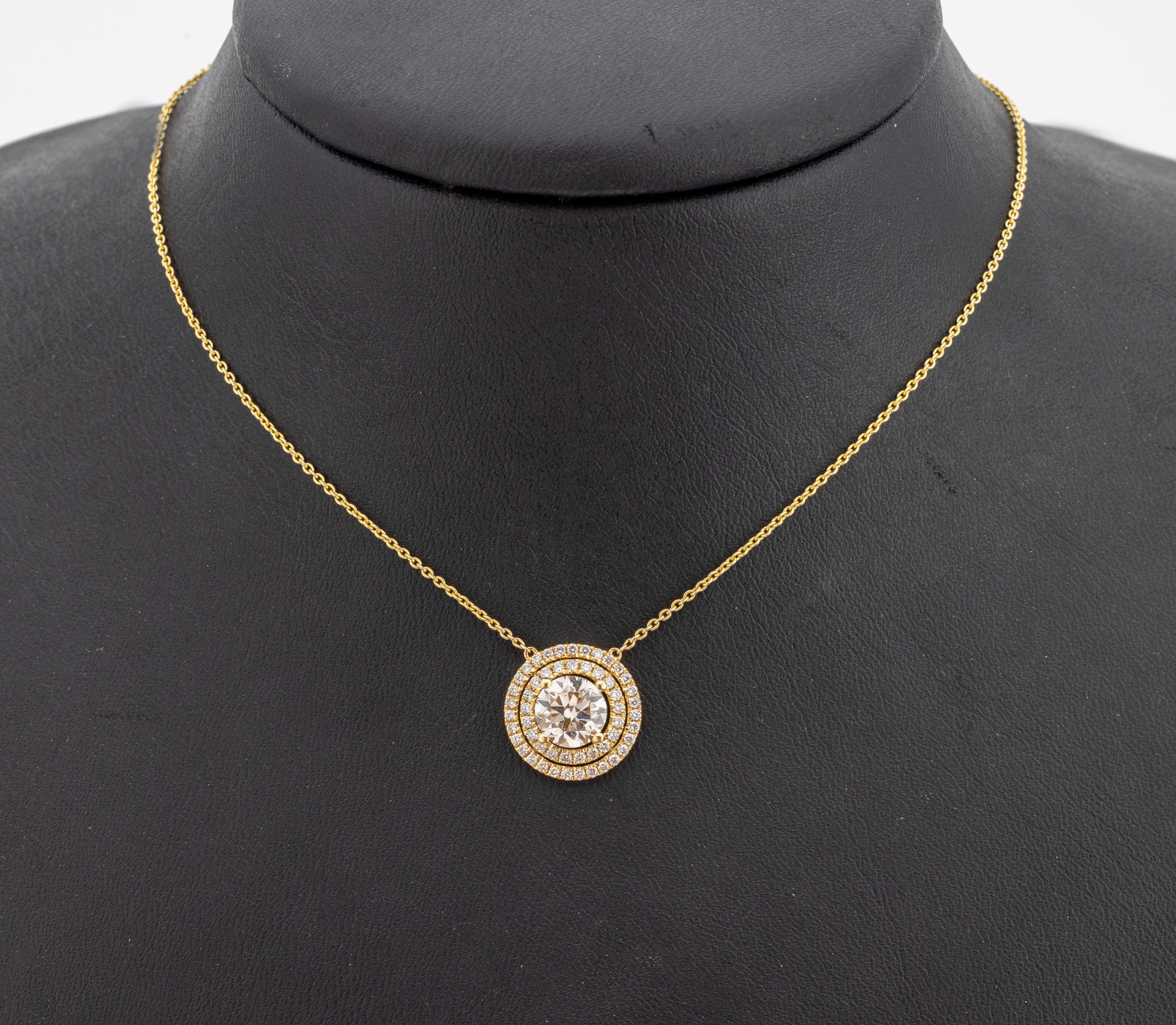 18 kt Gold Brillant-Collier, GG 750/000, Brillant ca. 1.35 ct l.get.Weiß/vs, umgeben von Brillanten zus. ca. 0.38 ct feines Weiß-Weiß/vs-si, L. ...