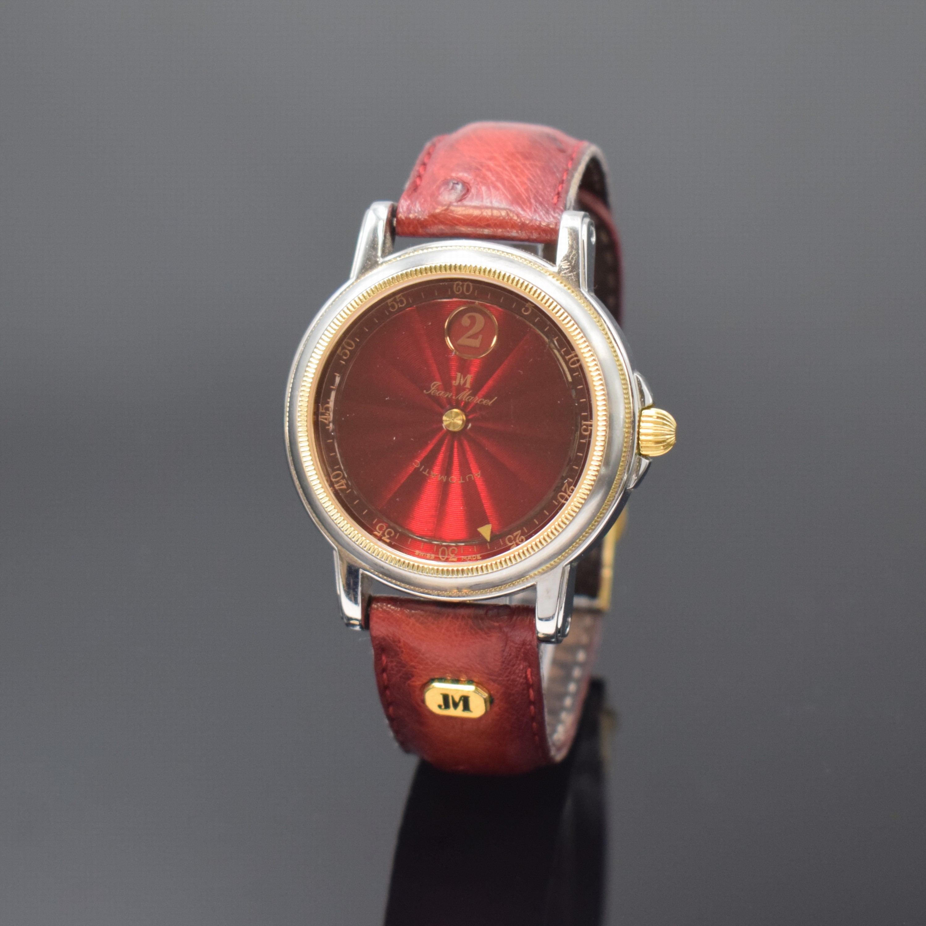 JEAN MARCEL Herrenarmbanduhr mit wandernder springender Stunde, Schweiz um 1995, Automatik, beids. vergl. Geh. in Stahl, Boden 4-fach verschr., Krone ...