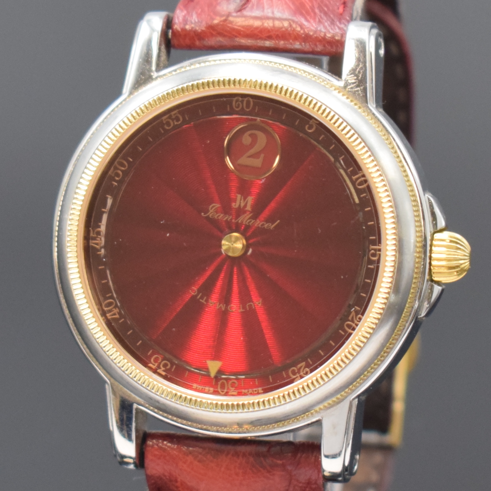 Detail a: JEAN MARCEL Herrenarmbanduhr mit wandernder springender Stunde, Schweiz um 1995, Automatik, beids. vergl. Geh. in Stahl, Boden 4-fach verschr., Krone ...
