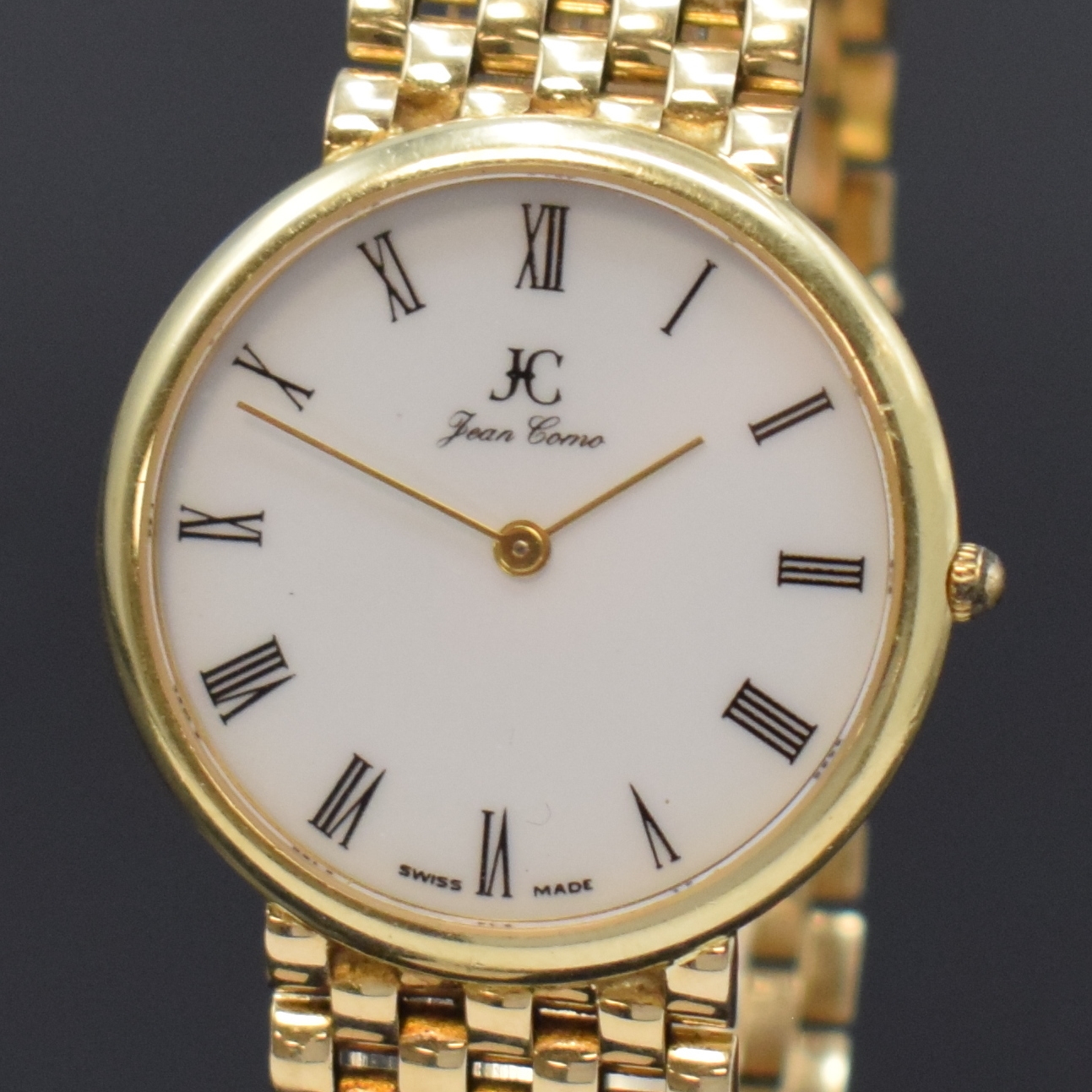Detail a: JEAN COMO auf 498 Stück imitierte Armbanduhr in GG 585/000, Schweiz um 1980, quarz, Goldband, Boden aufgedr., weißes Zifferbl. m. röm. Zahlen, ...