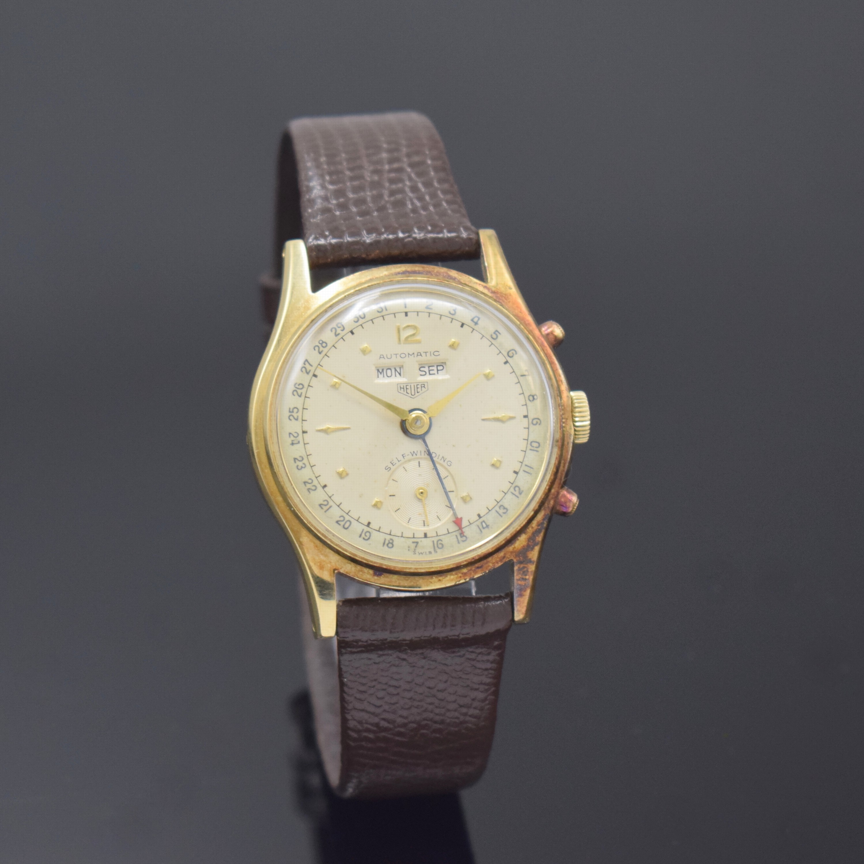 HEUER Automatic seltene Armbanduhr mit Vollkalender in GG 585/000, Schweiz um 1950, Hammerautomatik, 2-tlg. Geh., Boden verschr.,seitl. Korrekturdr. ...