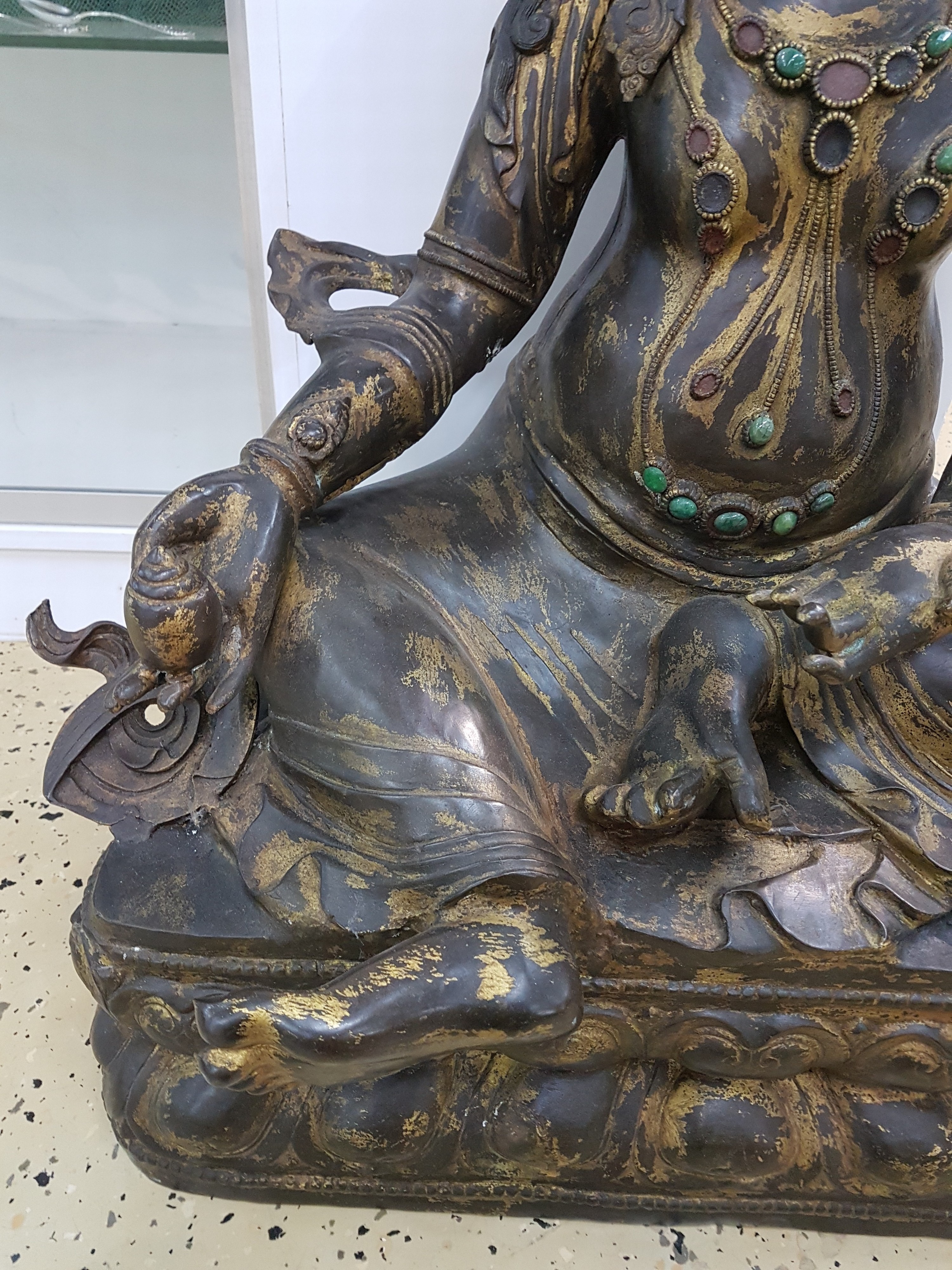 Detail e: Sehr große Altarskulptur der Gottheit Kubera, wohl Anfang 20. Jh., Bronze, z.T. vergoldet, Zitrone in der Hand, Attribut Mungo fehlt, ...