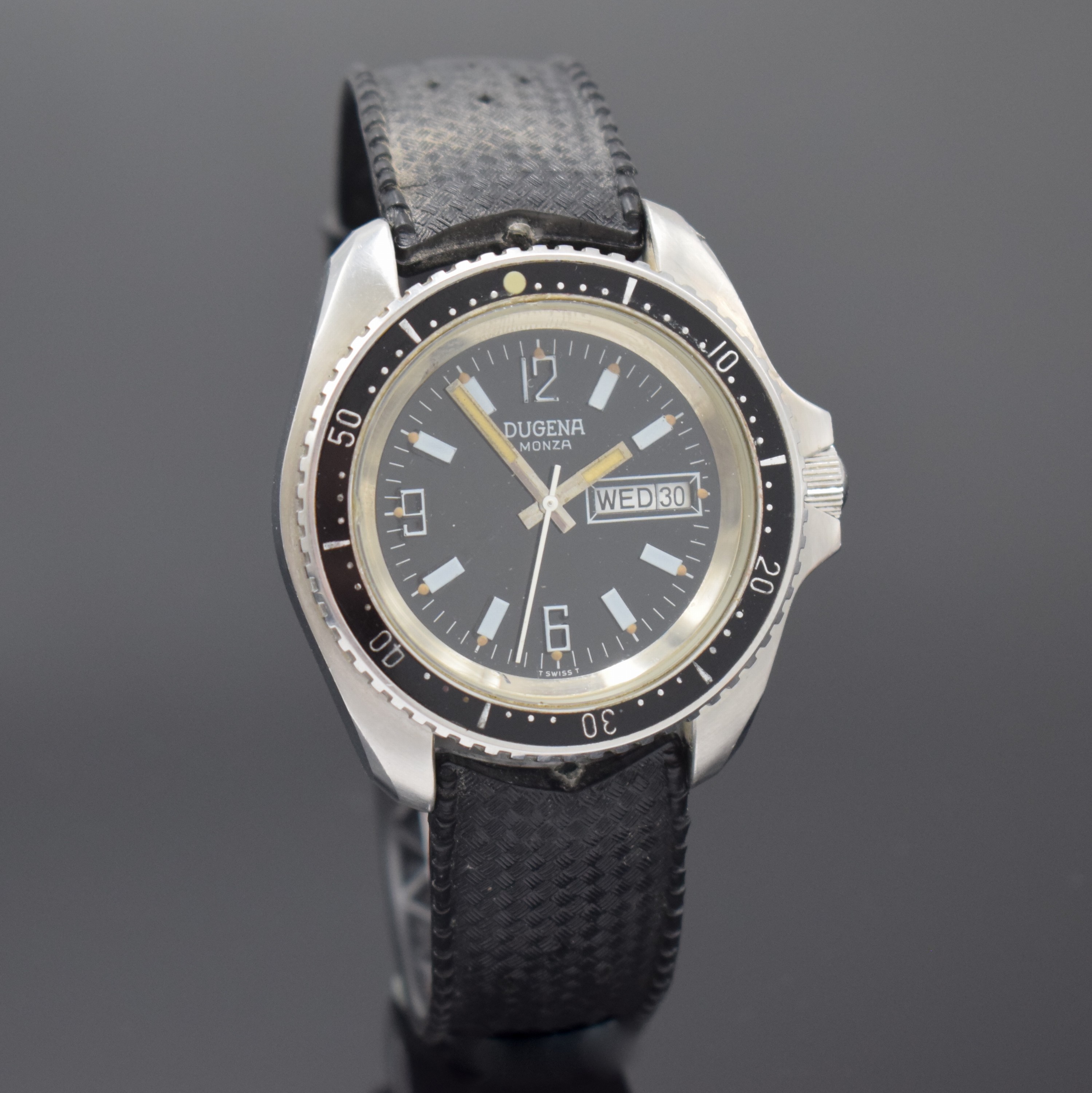 Detail b: DUGENA Monza Herrenarmbanduhr in Stahl, Schweiz um 1970, Automatik, Boden u. Krone verschr., Lünette m. 60er Teilung eins. drehb., schwarzes ...