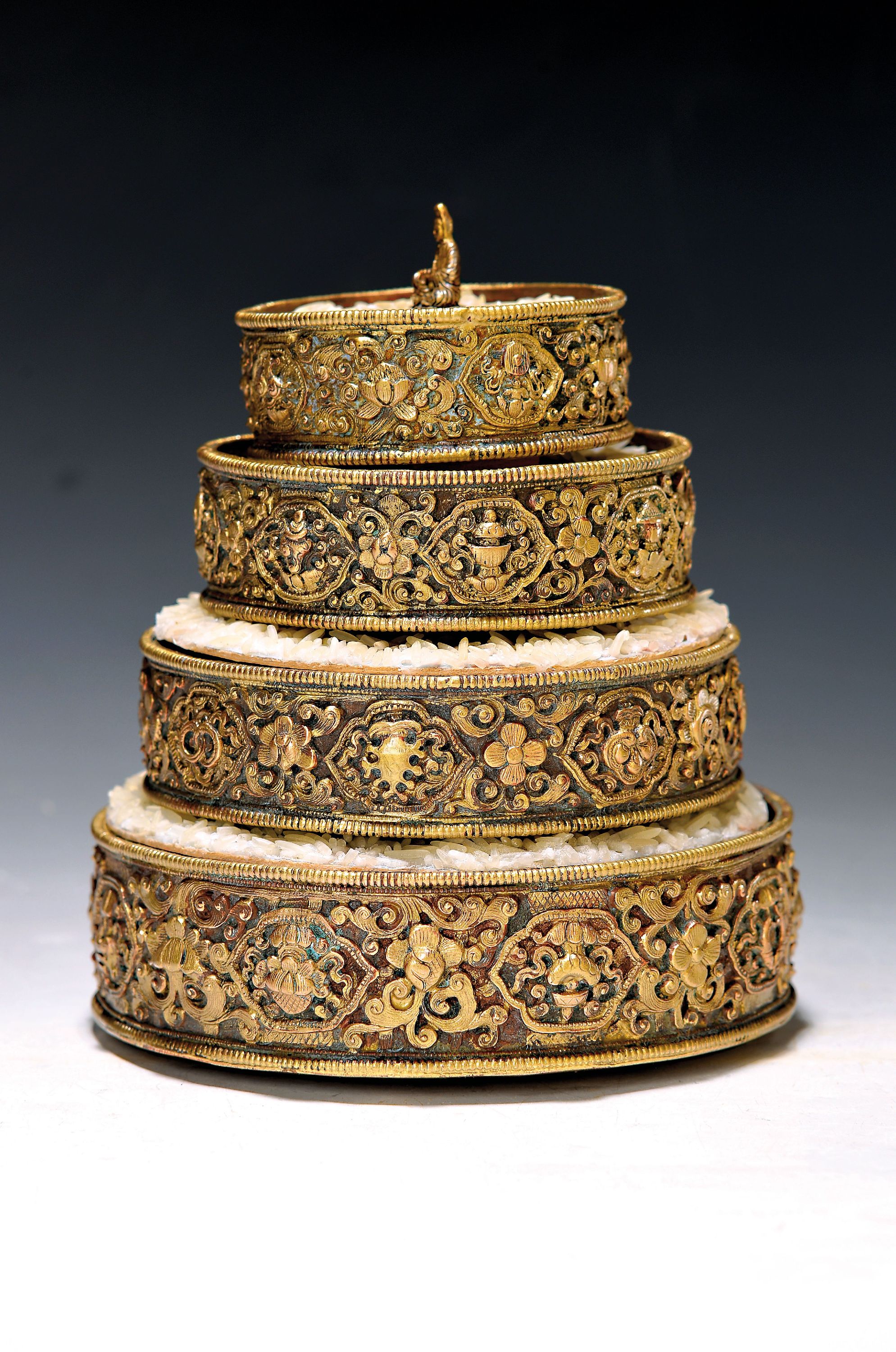 Vierteiliges Opfer-Mandala, Tibet, Ende 19. Jh., Bronze, reich reliefiert, vierstöckig, umlaufende 8 Glückssymbole, mit Lotusblumen, Ritualgefäß ...