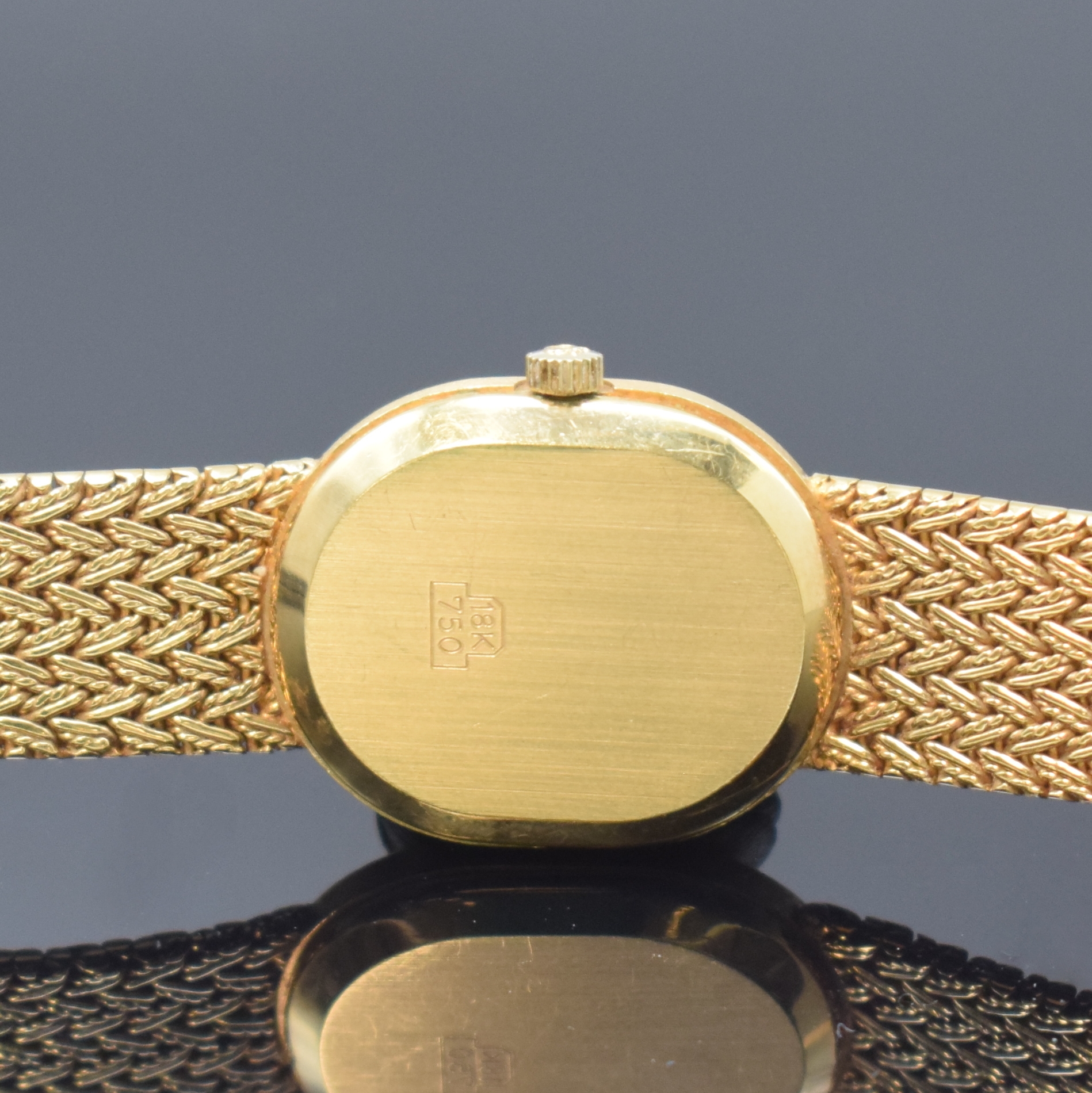 Detail e: MILUS Damenarmbanduhr in GG 750/000, Schweiz um 1975, quarz, Boden aufgedr., orig. Gold- Flechtband, gold. Zifferbl. m. schwarzen Zeigern, M. 27 x ...