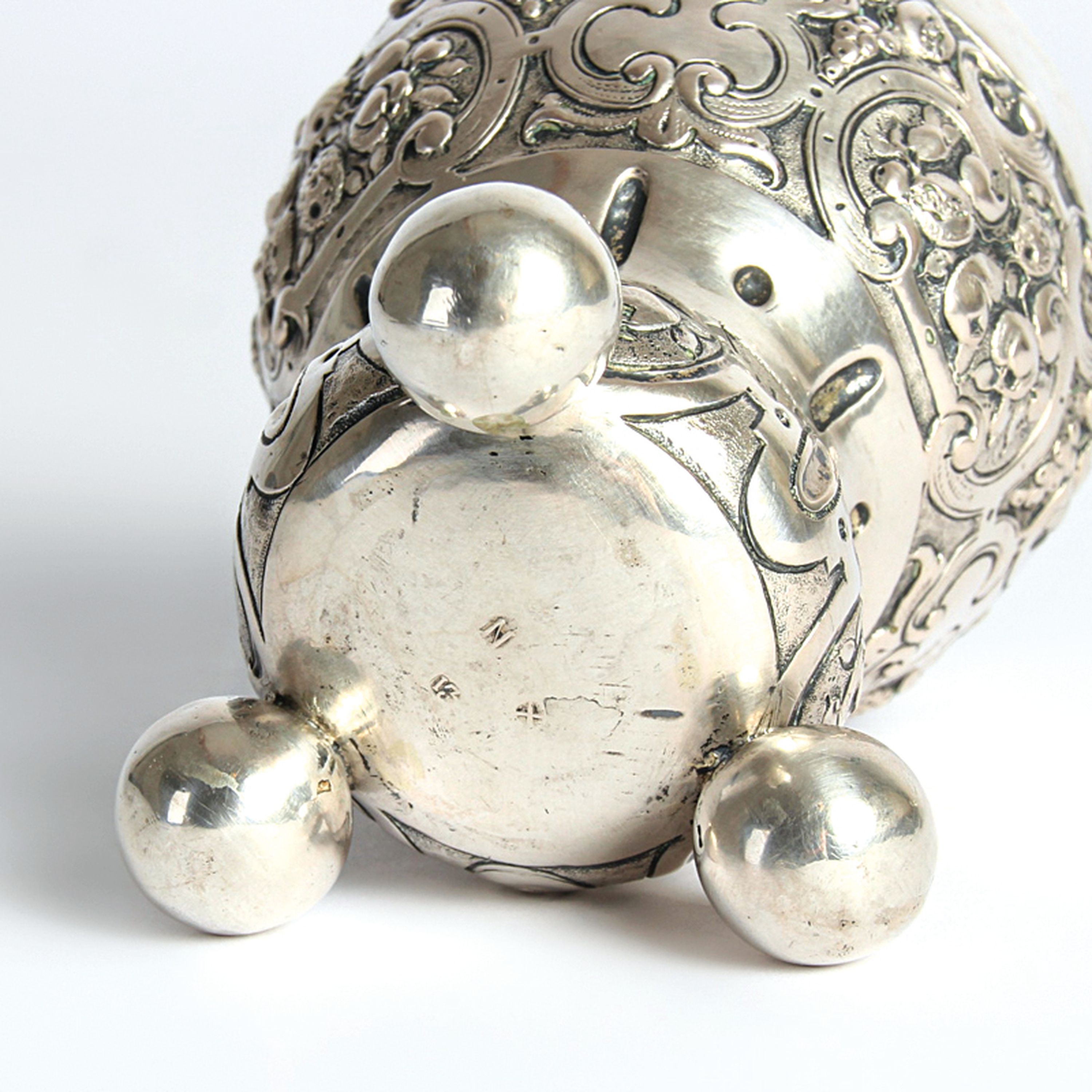 Detail e: Kugelfußbecher, Nürnberg, 18.Jh., 13 Lot Silber, Dekor mit Rollwerk und Früchten, auf drei großen Kugelfüßen, 119g, H. 10 cm, Meistermarke N