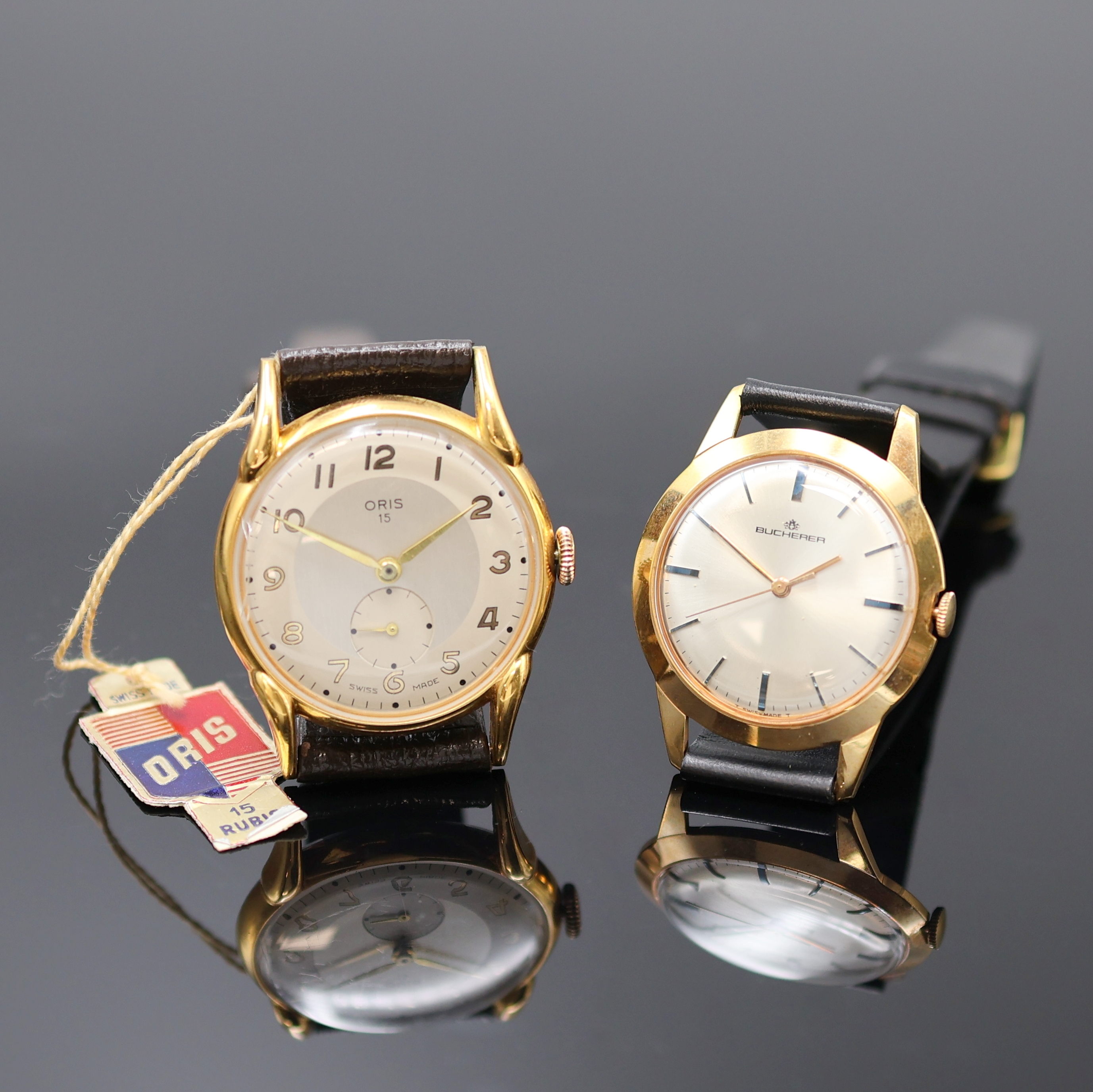 ORIS und BUCHERER 2 Armbanduhren, Schweiz 1950er Jahre, Handaufzug, verg. Gehäuse, Böden aufgedr., silb. Zifferblätter, arab. Zahlen u. gebl. ...