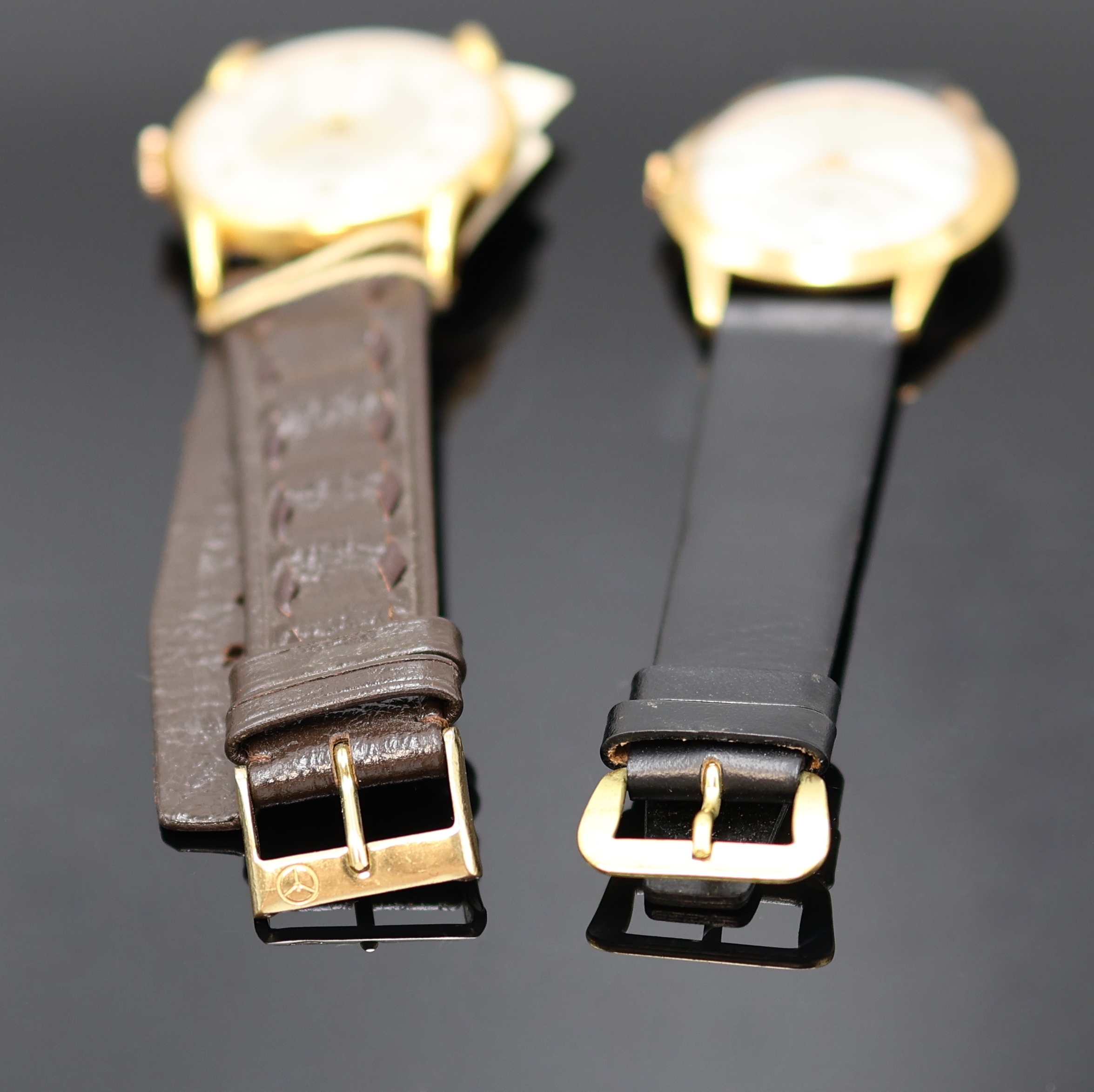 Detail c: ORIS und BUCHERER 2 Armbanduhren, Schweiz 1950er Jahre, Handaufzug, verg. Gehäuse, Böden aufgedr., silb. Zifferblätter, arab. Zahlen u. gebl. ...