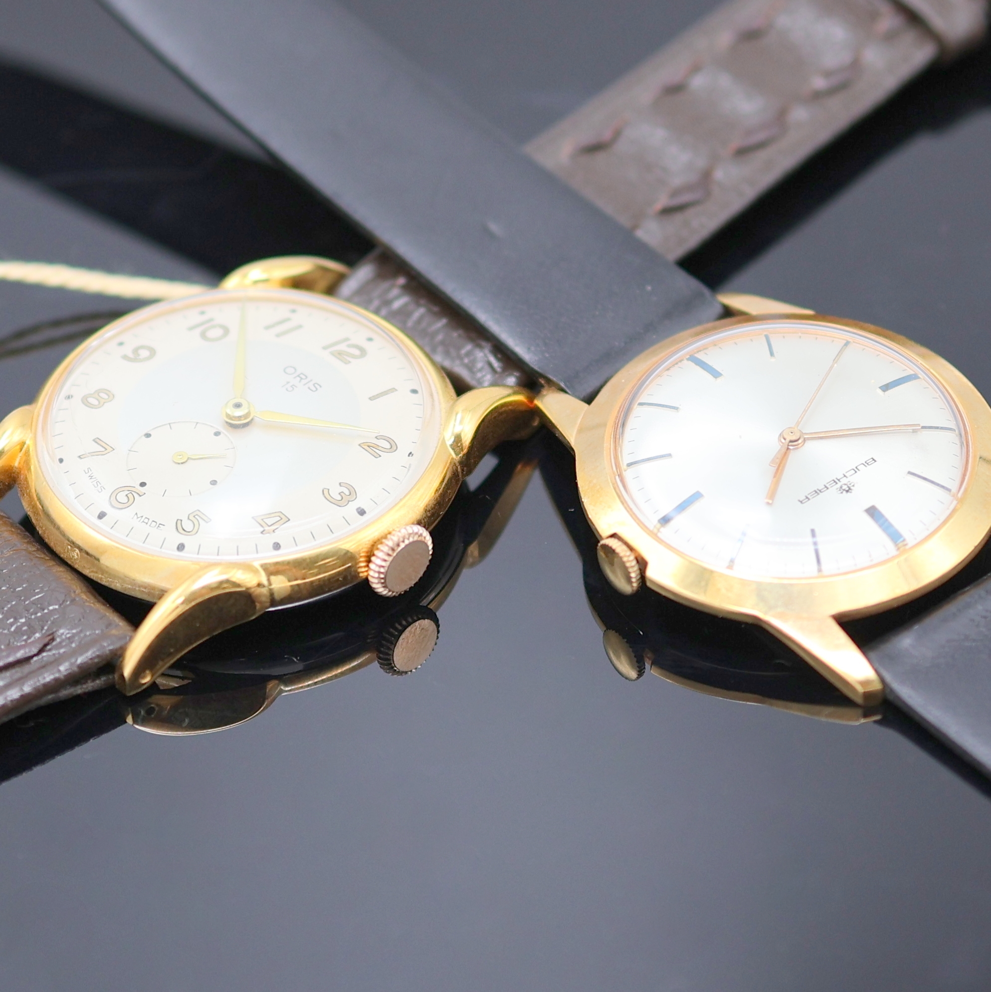 Detail d: ORIS und BUCHERER 2 Armbanduhren, Schweiz 1950er Jahre, Handaufzug, verg. Gehäuse, Böden aufgedr., silb. Zifferblätter, arab. Zahlen u. gebl. ...