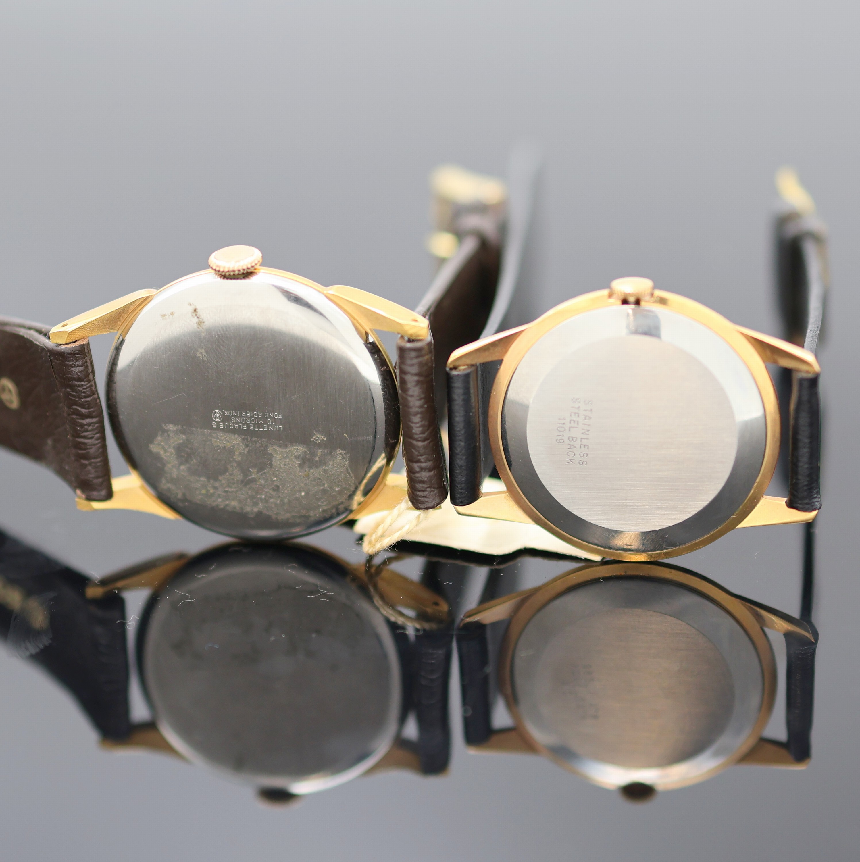 Detail e: ORIS und BUCHERER 2 Armbanduhren, Schweiz 1950er Jahre, Handaufzug, verg. Gehäuse, Böden aufgedr., silb. Zifferblätter, arab. Zahlen u. gebl. ...