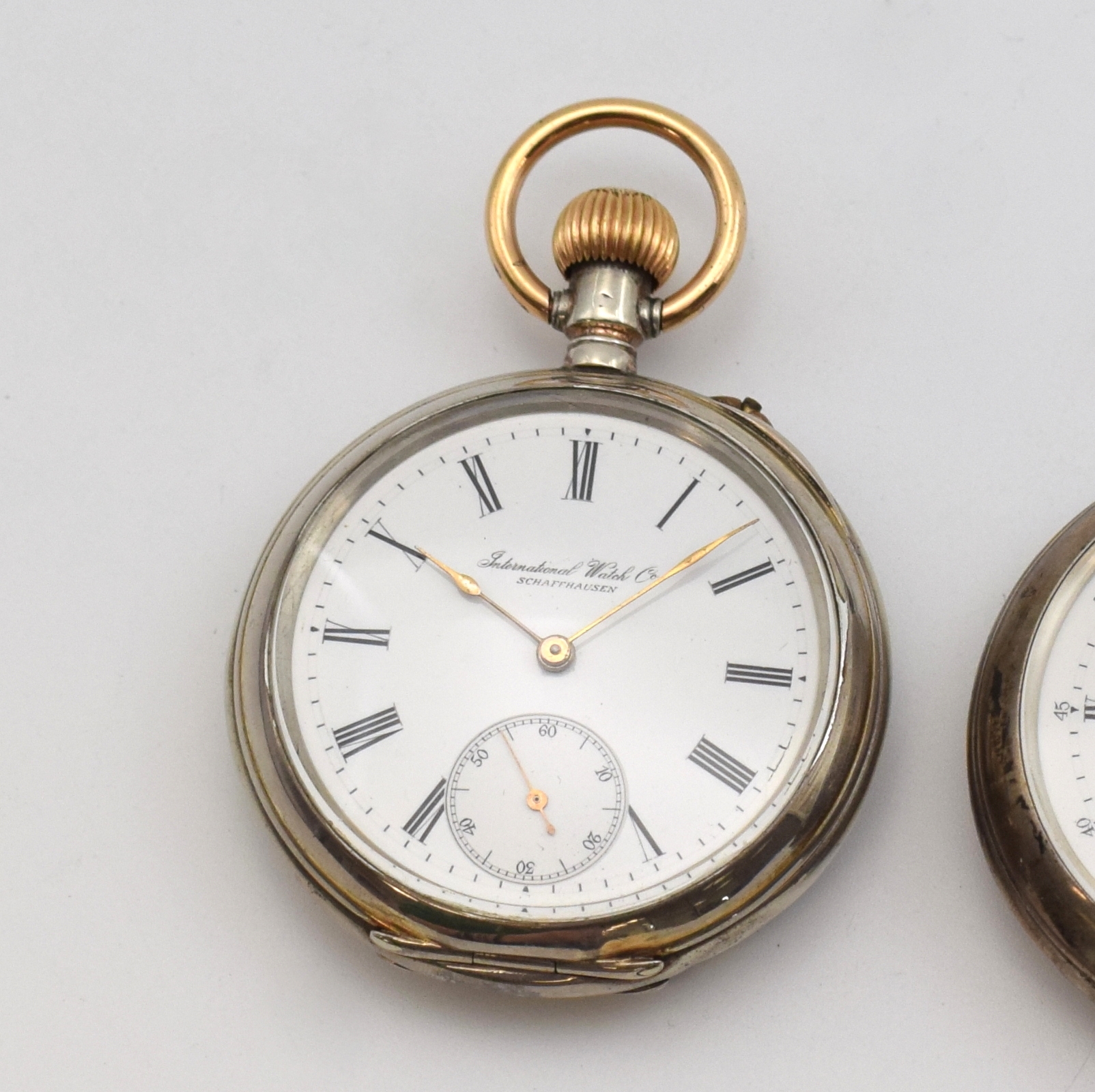 Detail a: IWC 2 frühe offene Silbertaschenuhren, Schweiz um 1890, Scharniergeh. m. Silbercuvette, 1 x guill. berieb., 1 x glatt, sign. Emailzifferblätter 1 x ...