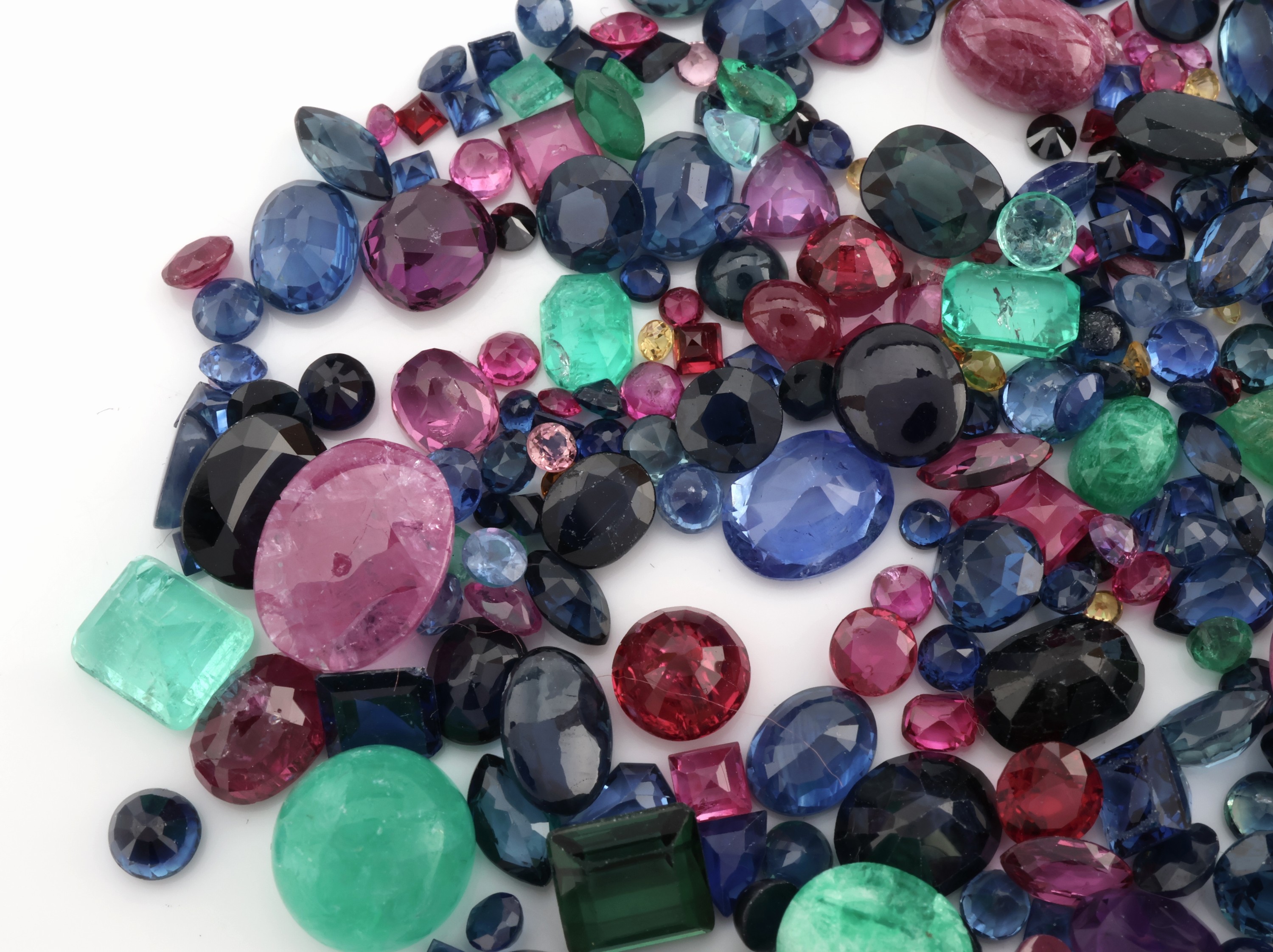 Detail b: Lot lose Farbsteine zus. ca. 108 ct, darunter überwiegend Rubine, Smaragde und Saphire, versch. Schliffformen
