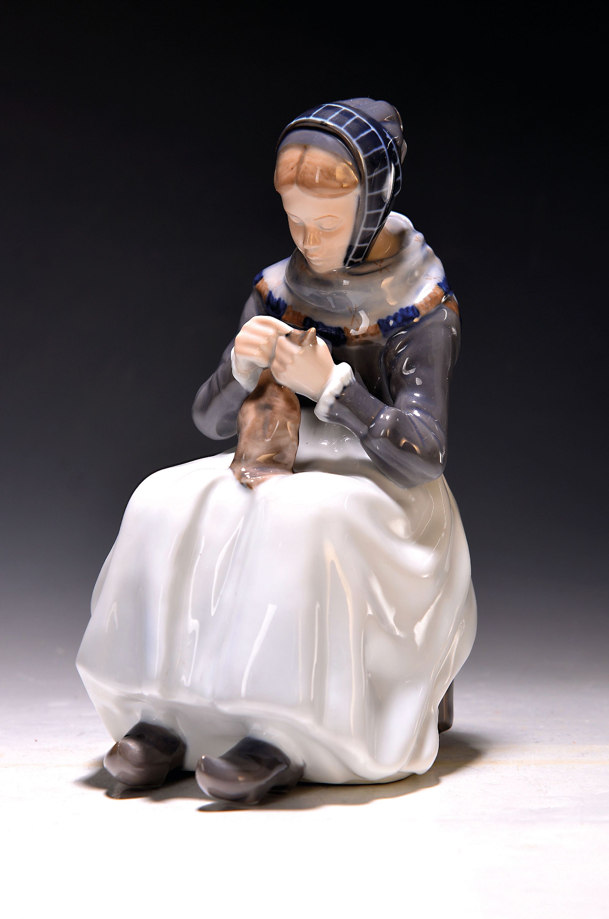 Porzellanfigur, Royal Copenhagen, 1965, Entw. Lotte Benter 1911, Porzellan farbig staffiert, Strickende Frau in Amager Tracht, am Boden signiert, H. ...