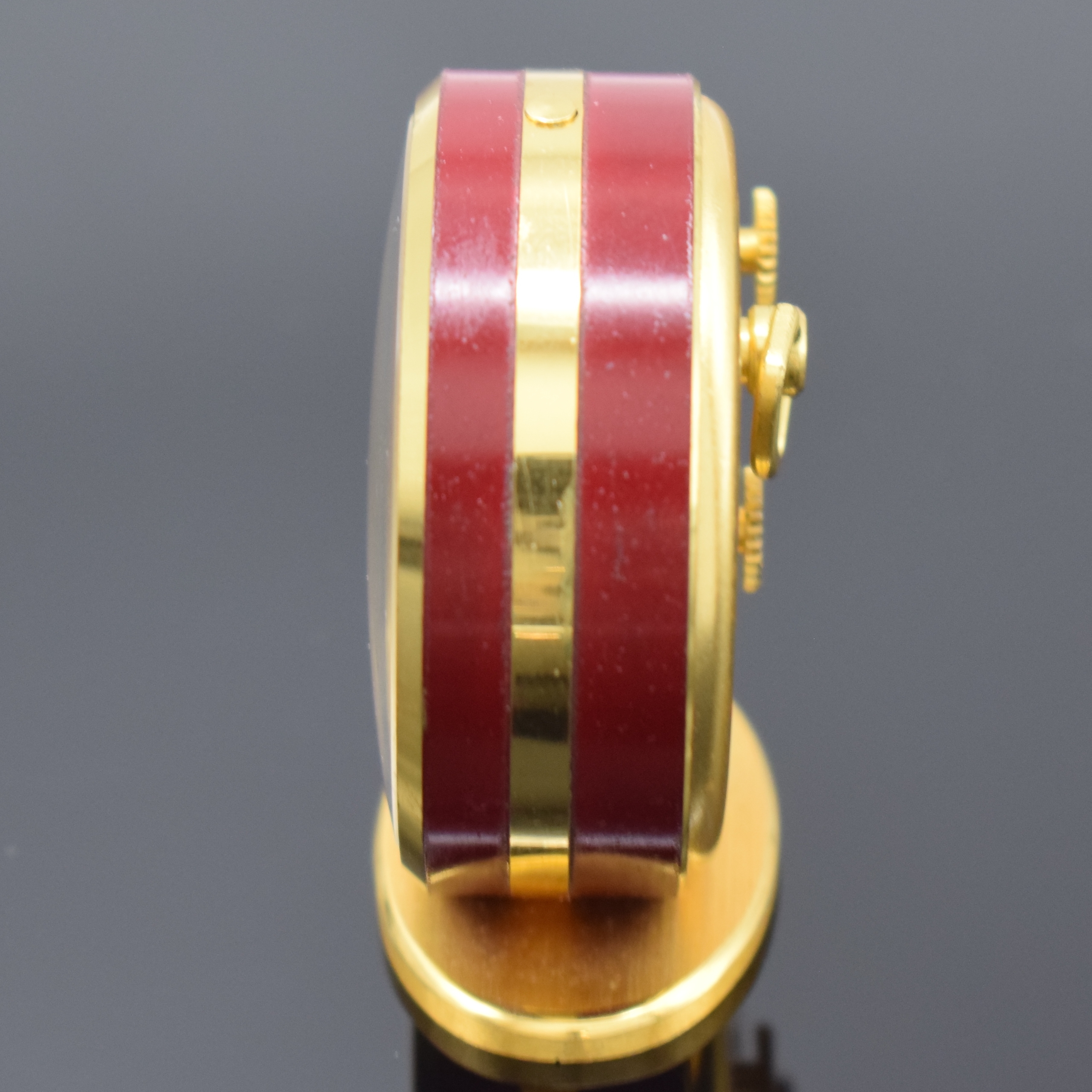 Detail a: JAEGER kleiner Tischwecker mit 8-Tagewerk, Schweiz um 1960, verg., teils rot lack. Gehäuse, silb. Duoton-Zifferbl. m. aufges. gold. Std.-Ind. u. ...