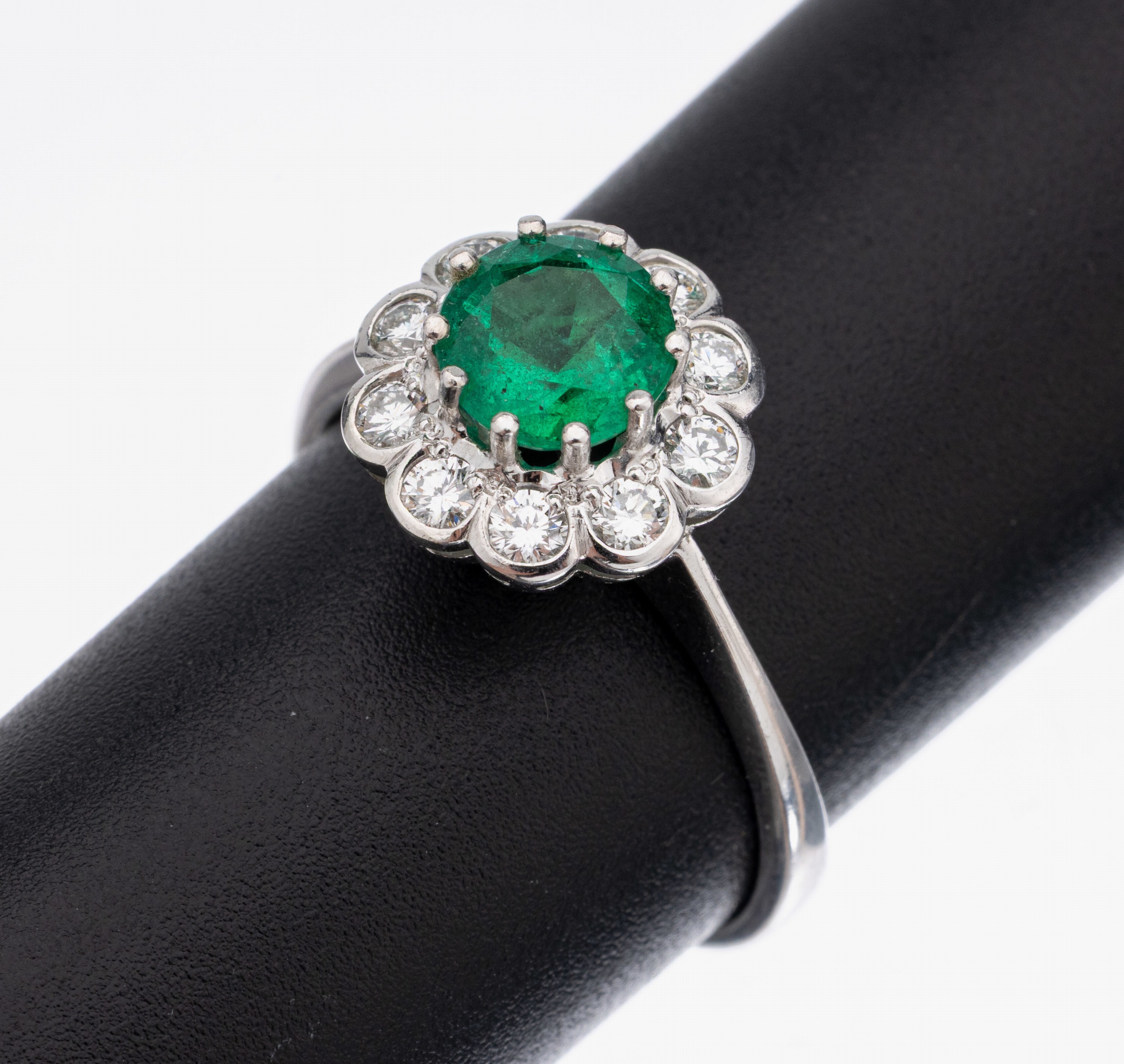 14 kt Gold Smaragd-Brillant-Ring, WG 585/000, mittig ein rundfacett. Smaragd ca. 1.25 ct von feiner Farbe, umgeben von 10 Brillanten zus. ca. 0.50 ...