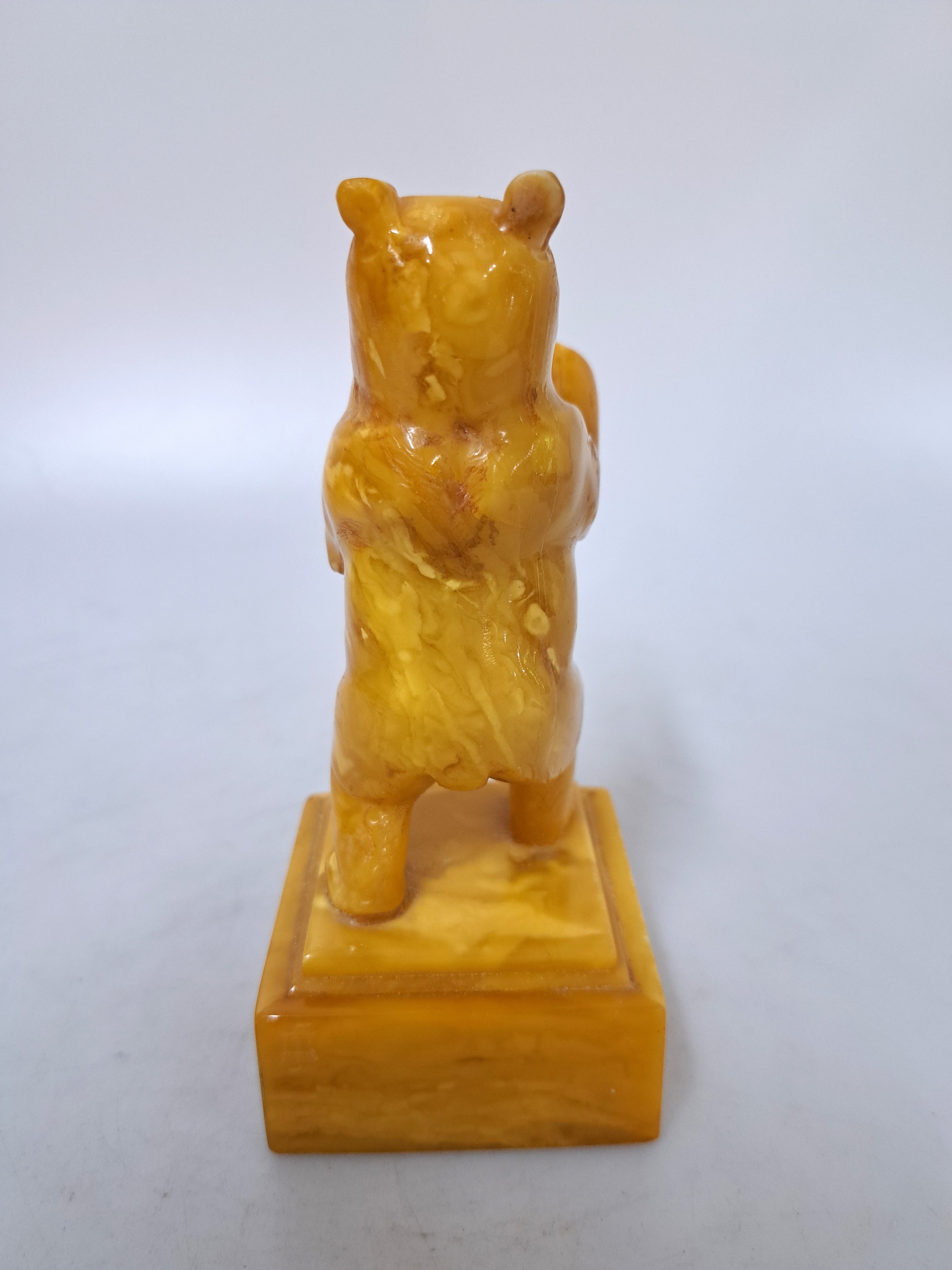 Detail c: Alfred Schlegge, 1923 - 2015, Berliner Bär, Bernstein geschnitzt, an einem Ohr rest., monogrammiert, H. ca. 14 cm