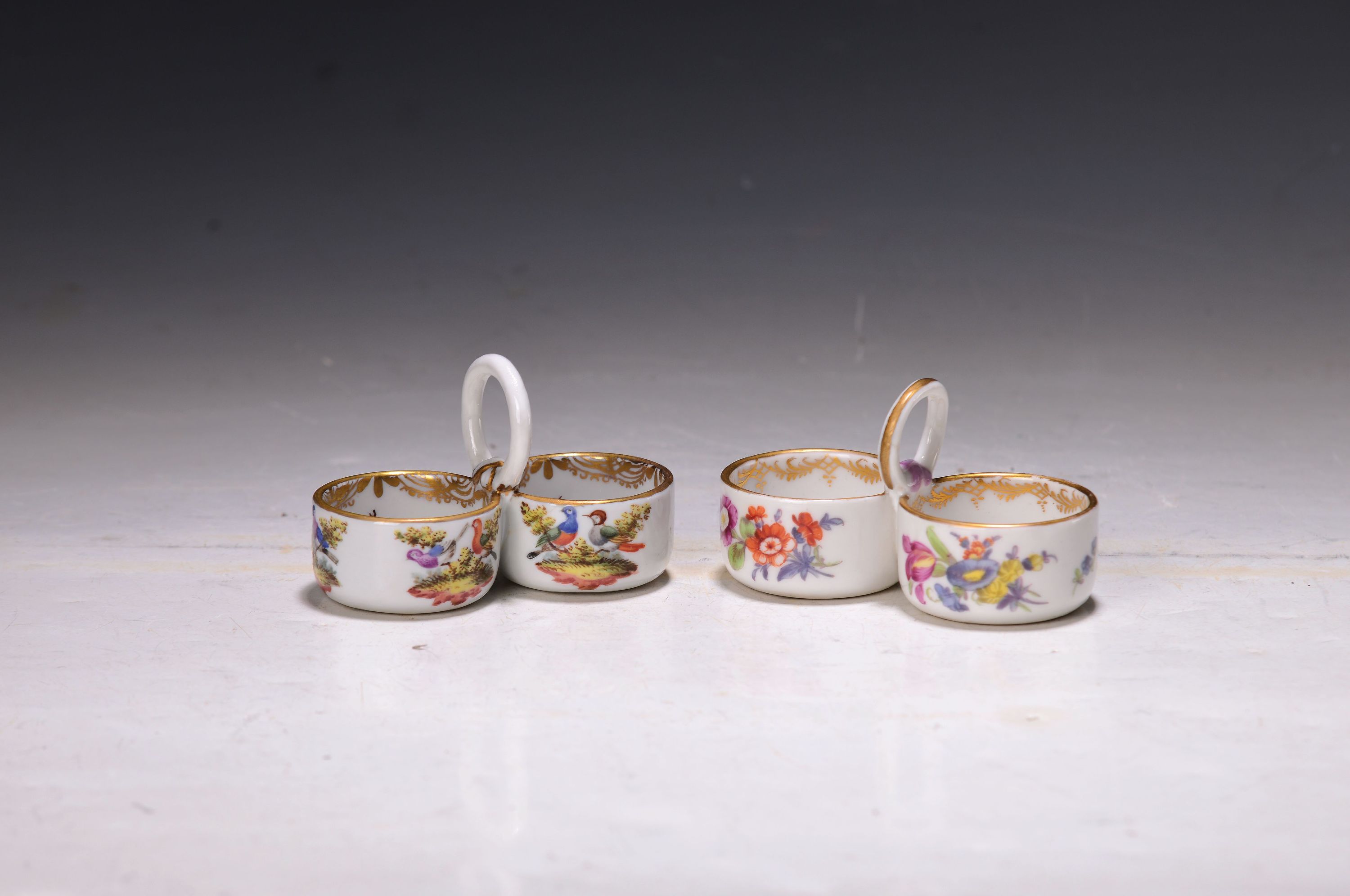Zwei Gewürzschälchen, Meissen, um 1890/1900, jeweils Doppelschälchen, polychrom bemalt, einmal mit umlaufender Blumenmalerei u. Goldstaffage; ...