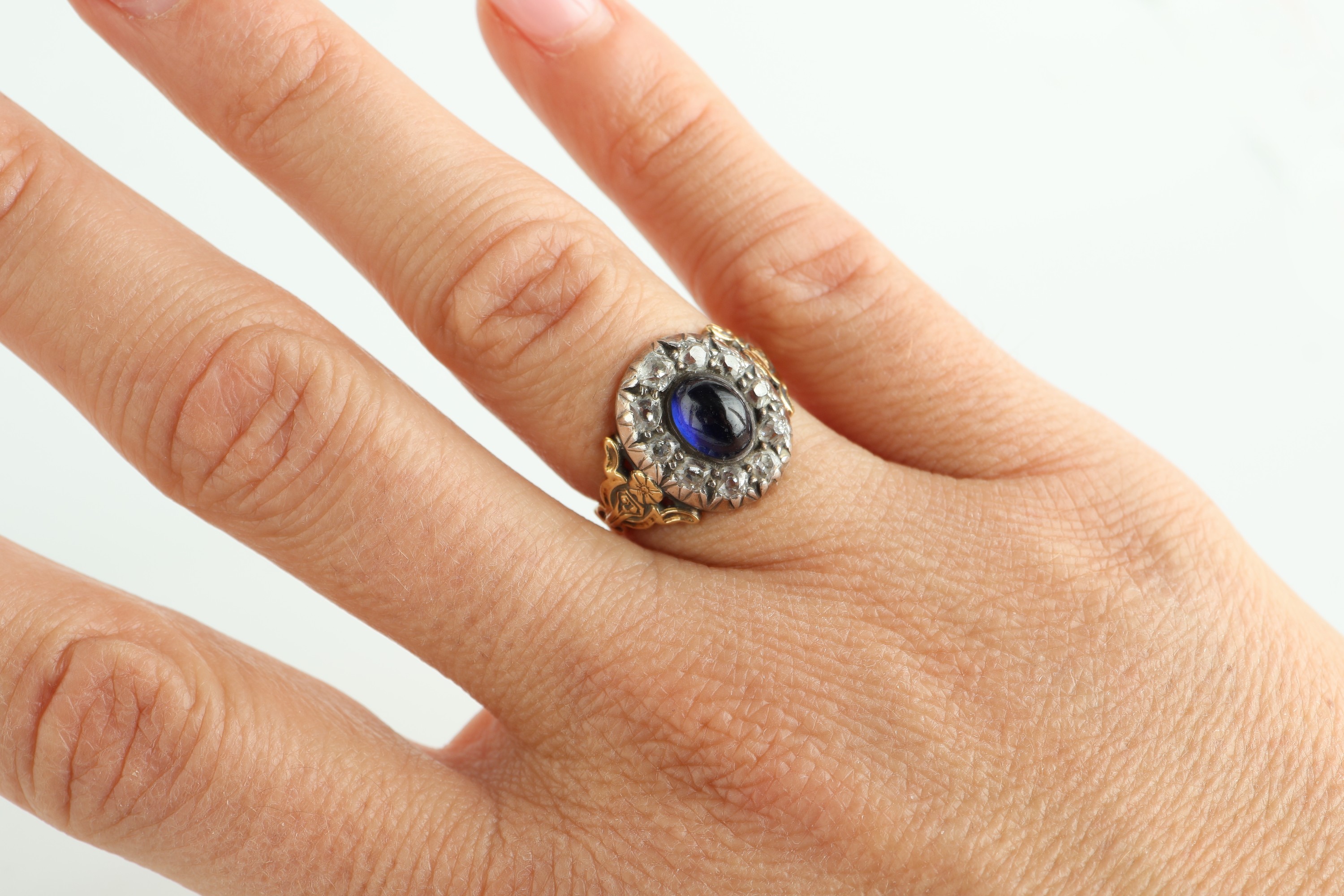 Detail c: 14 kt Gold Saphir-Diamant-Ring, um 1880-90, GG 585/000 gepr., Ringkopf zeittyp. in Silber,mittig ovaler Saphir-Cabochon ca. 1.60 ct, umgeben von 10 ...