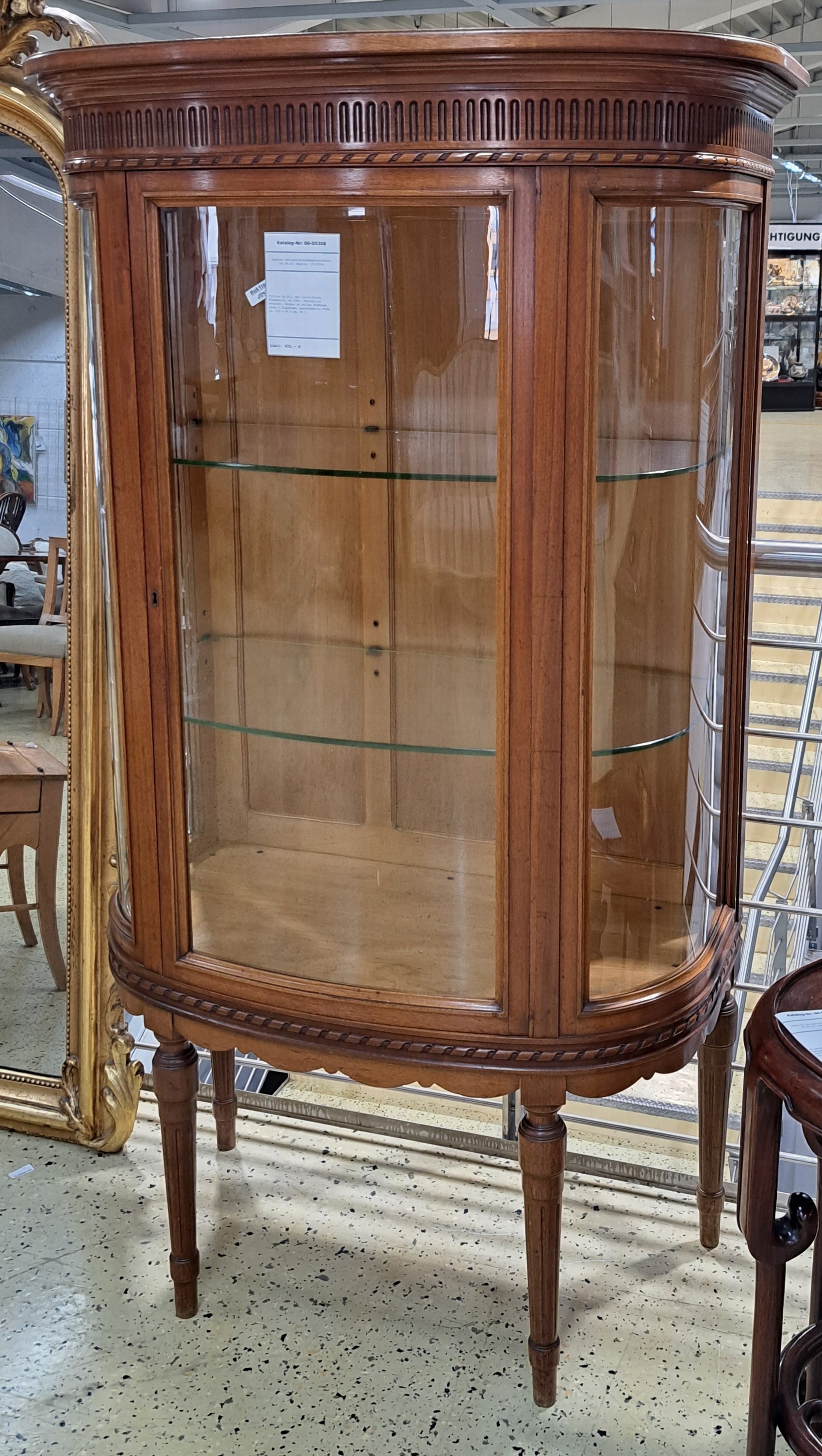 Detail b: Vitrine im Stil des Louis-Seize, Frankreich, um 1900, dreiseitig verglast, Korpus im hellen Nußbaum, innen 2 Glasböden, gedrechselte Füße, ca. ...