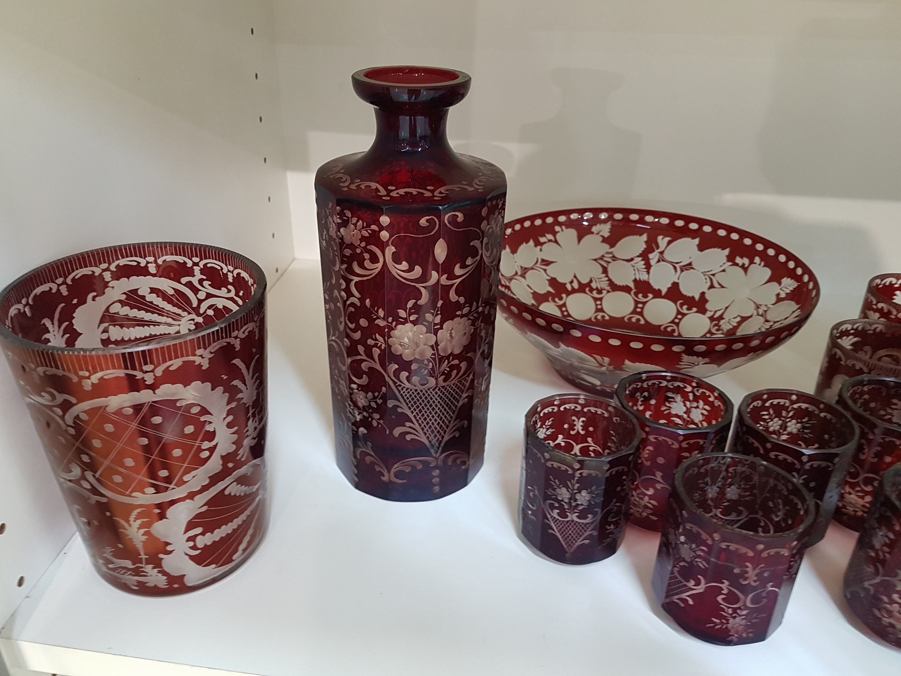 Detail a: Historismus Glasset, böhmisch, 19./20.Jh., farbloses Glas, rubiniert, floral-ornamentaler Dekor, Flasche (Stöpsel fehlt), 16 Gläser in z.T. leicht ...