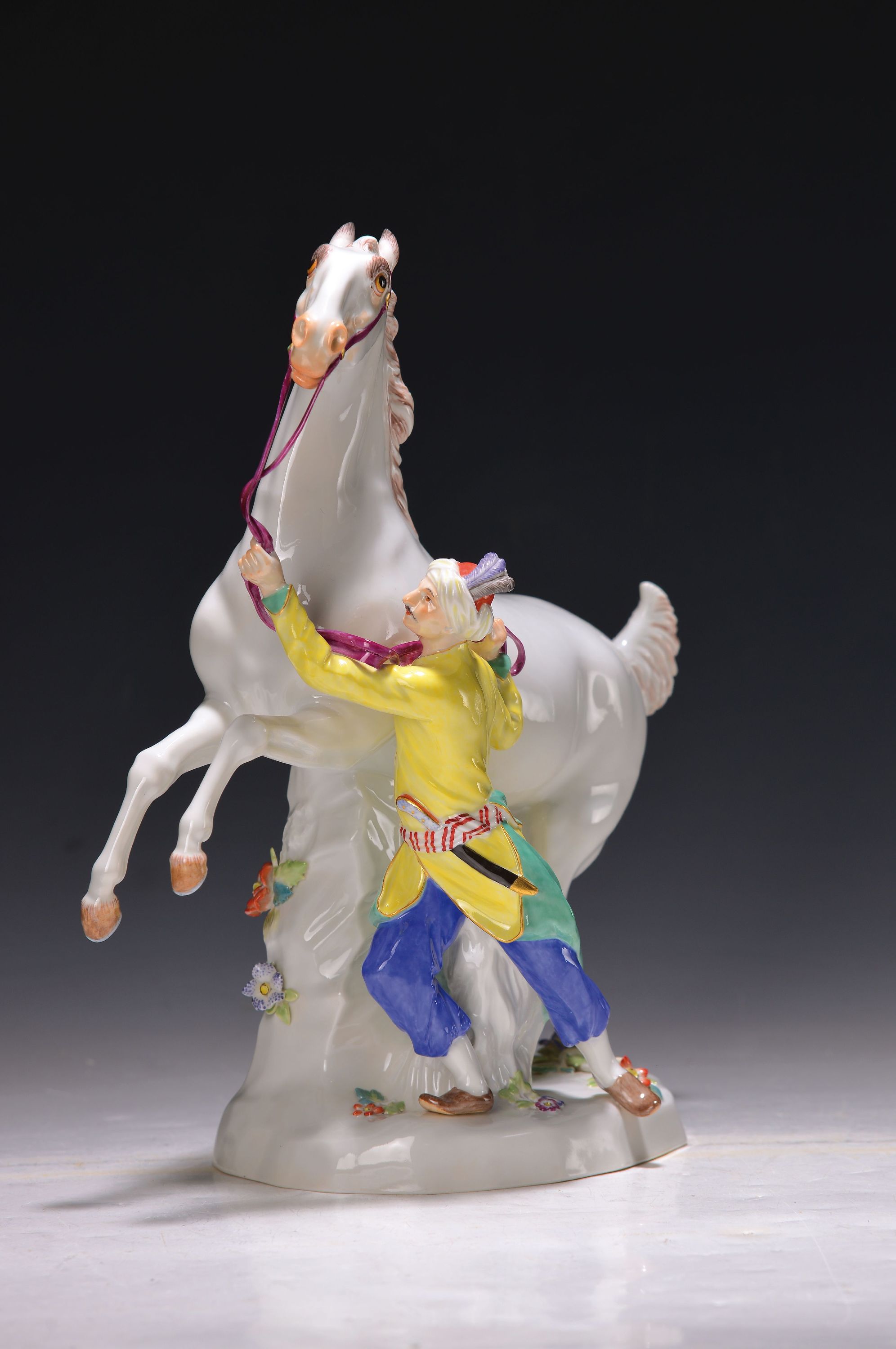 Detail a: Pferdebändiger, Meissen, 80/90er Jahre, Porzellan, steigender Pferd mit Orientale, polychrom bemalt, Sockel mit applizierten Blümchen, Modell ...