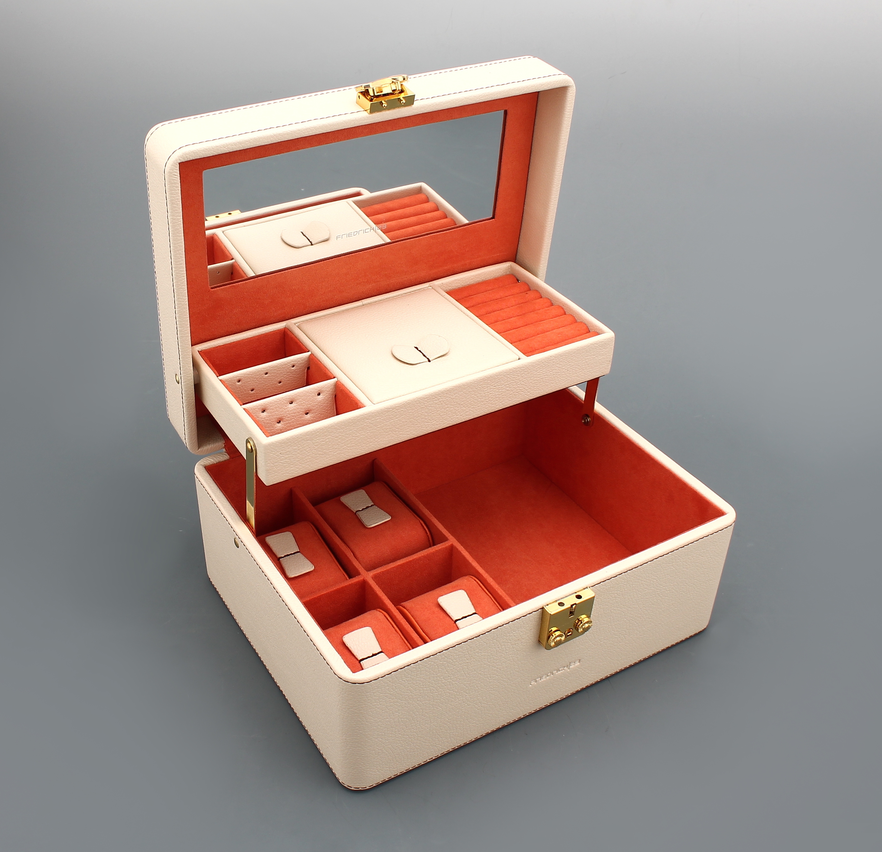 Detail a: Schmuck-/Uhrenkoffer aus elfenbeinfarb. Kunstleder, orangefarb. Innenausstattung, braune Nähte und brauner Tragegriff, Ringleisten, Ohrringleisten, ...