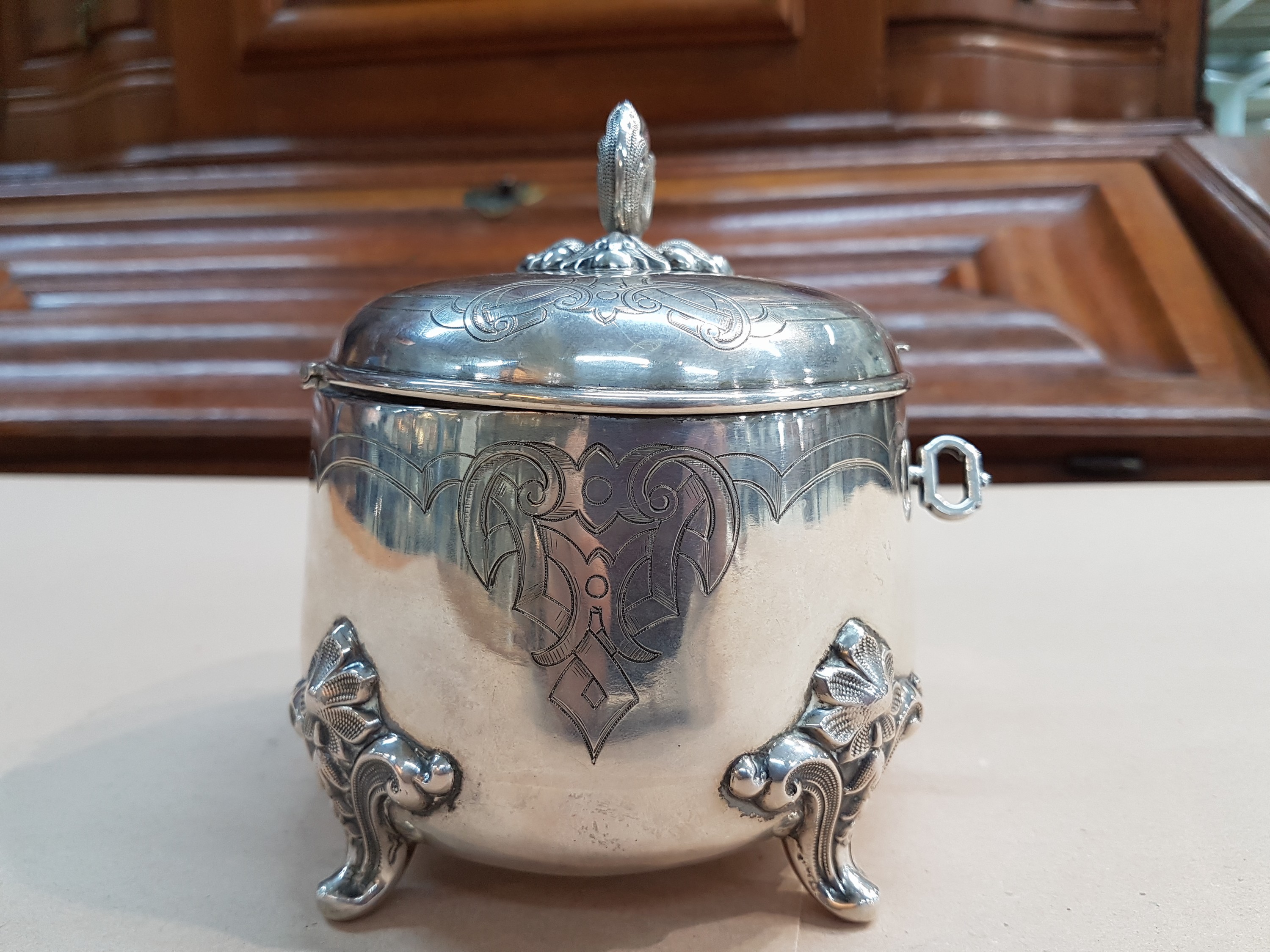 Detail d: Deckeldose/Zuckerdose, deutsch, um 1840, 750er Silber, gravierter Dekor auf Wandung und Deckel, vier geschweifte Füße, Schlüssel und Schloß, ca. ...
