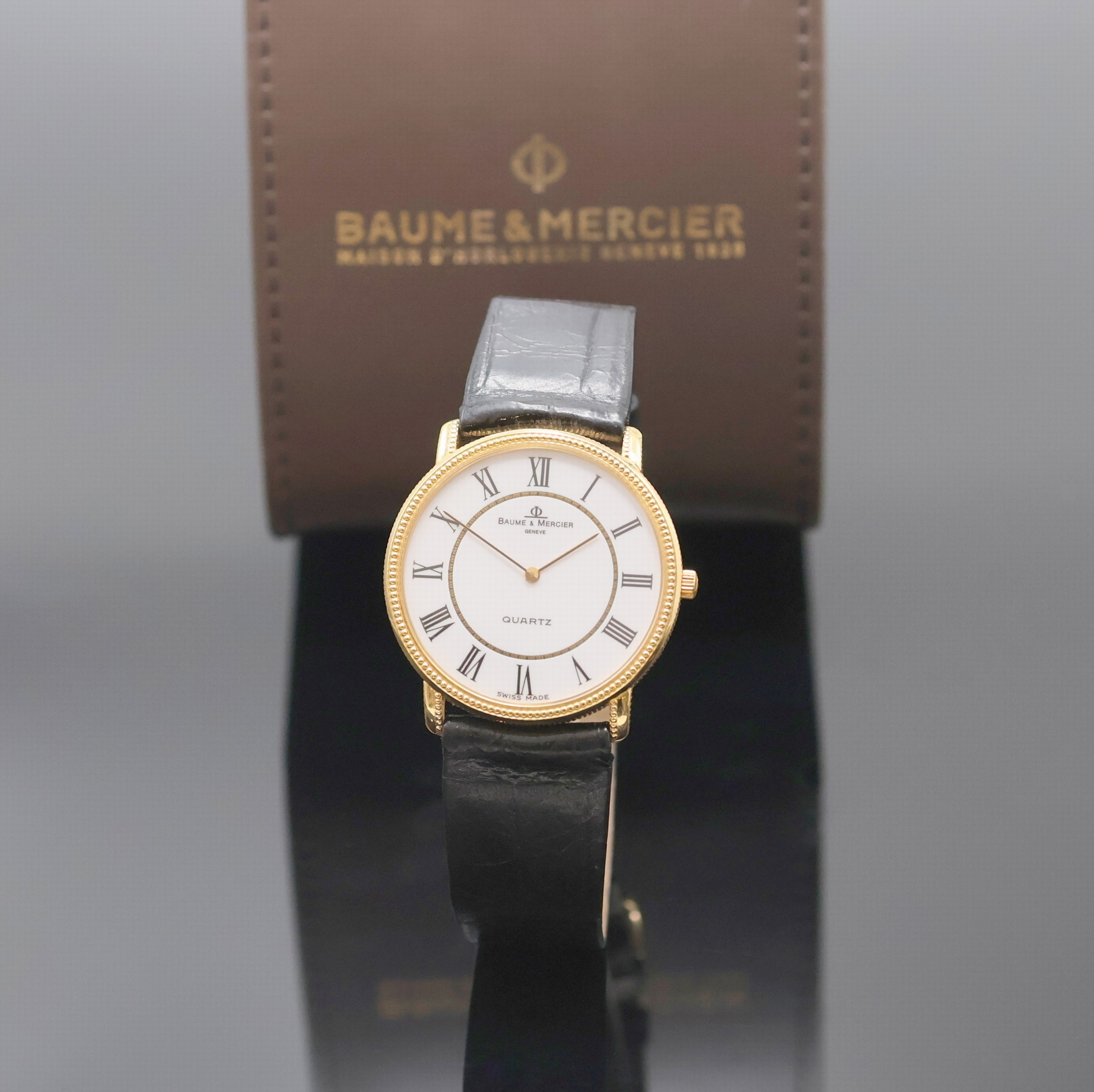 BAUME & MERCIER elegante Armbanduhr in GG 750/000 Referenz 15101, Schweiz um 1990, quarz, 2-tlg. Geh. m. Münzrand u. Perllünette,Boden aufgedr., ...