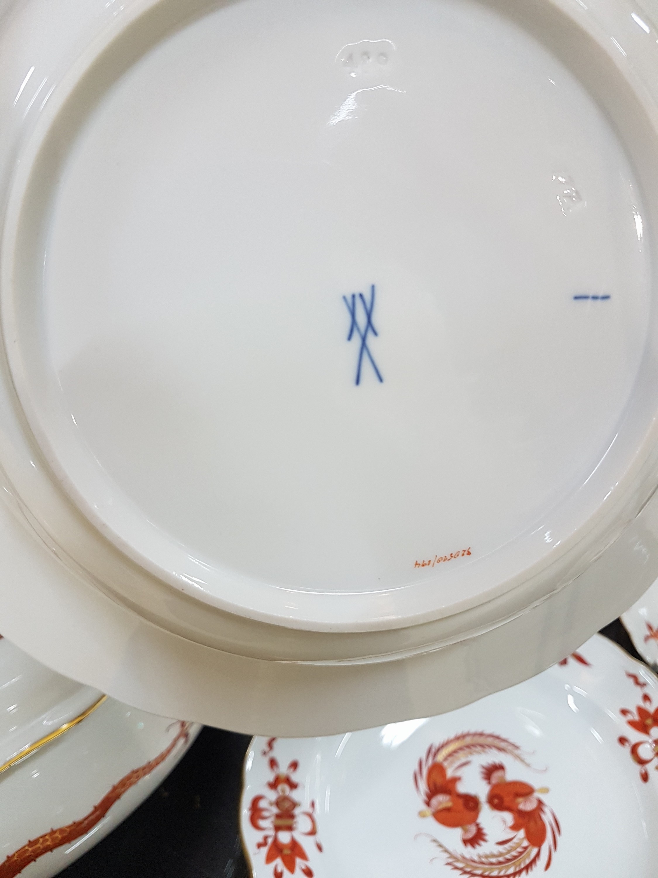 Detail l: Speiseservice, Meissen, 20. Jh., 1. Wahl, Dekor roter Hofdrache goldschattiert, 11 flache Teller, 3 tiefe Teller (davon einer 2. Wahl), 6 ...