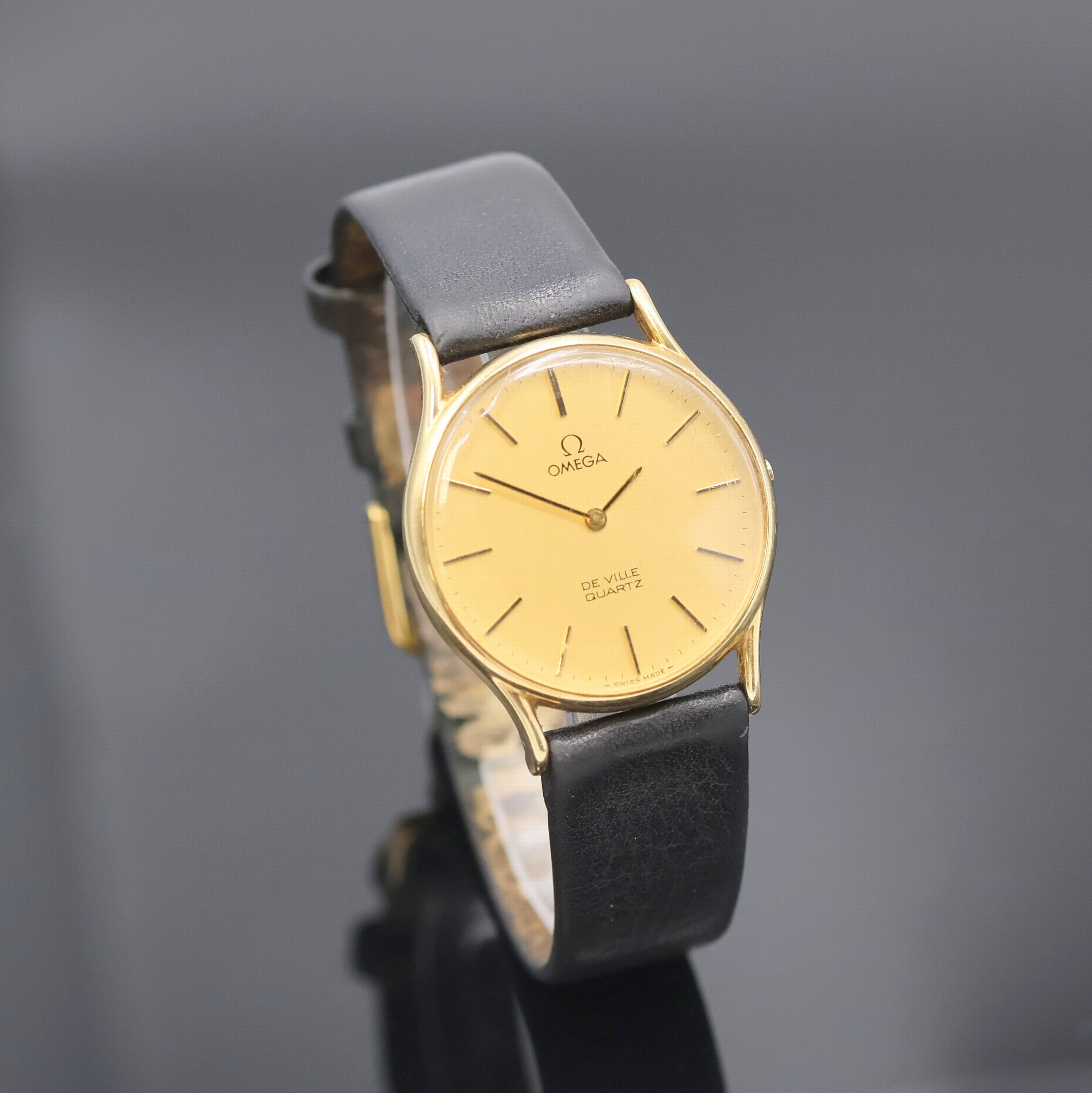 Detail b: OMEGA Armbanduhr In GG 585/000 Referenz 191 0056 mit Box, Schweiz um 1980, quarz, 2- teil. Geh. m. aufgedr. Boden, gold. Zifferbl. m. gold. ...