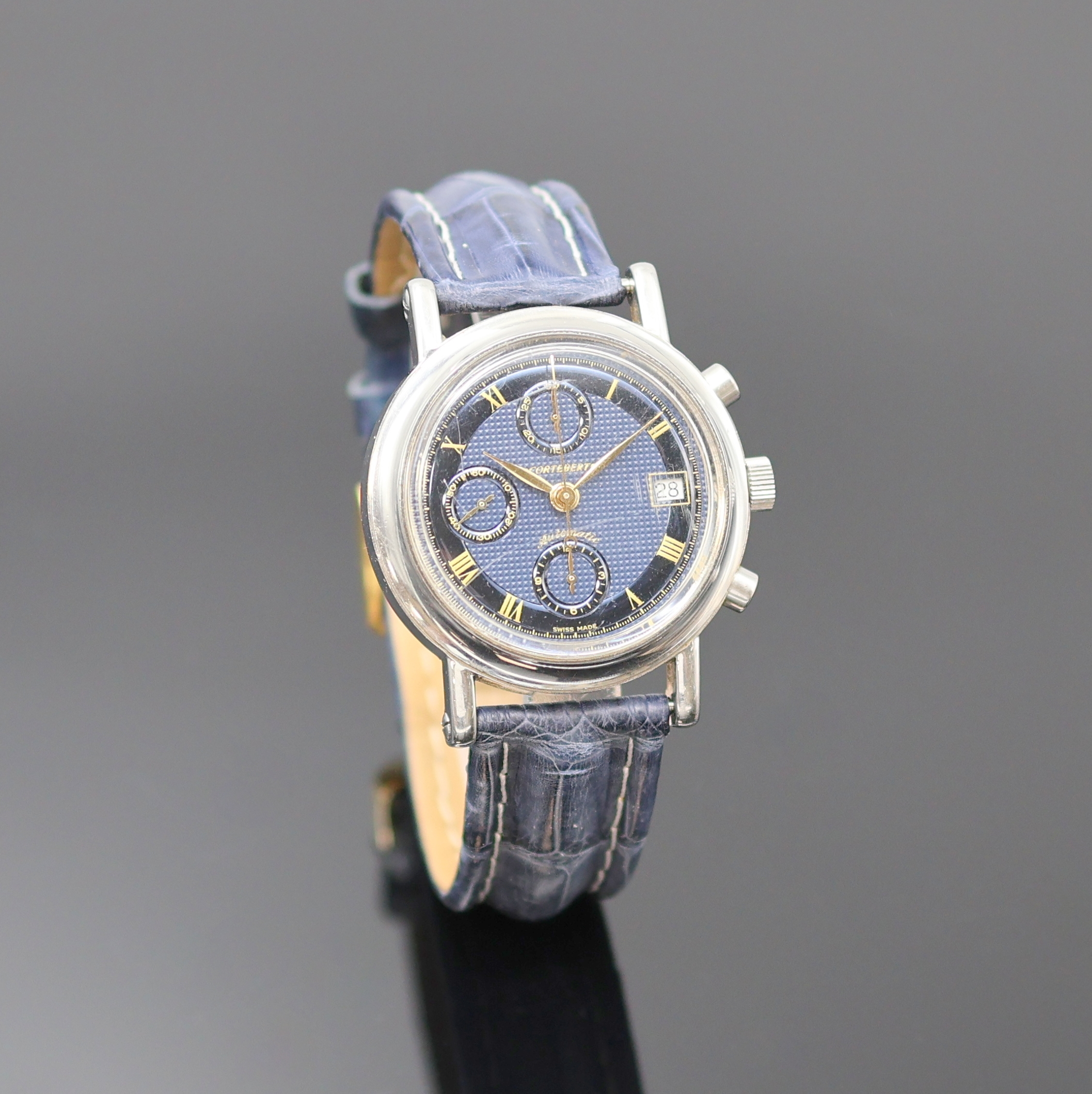 Detail b: CORTEBERT Armbandchronograph, Automatik, Schweiz um 1990, Edelstahlgeh., Boden verschr., blues, im Zentrum guill. Zifferbl. m. röm. Std., gold. ...