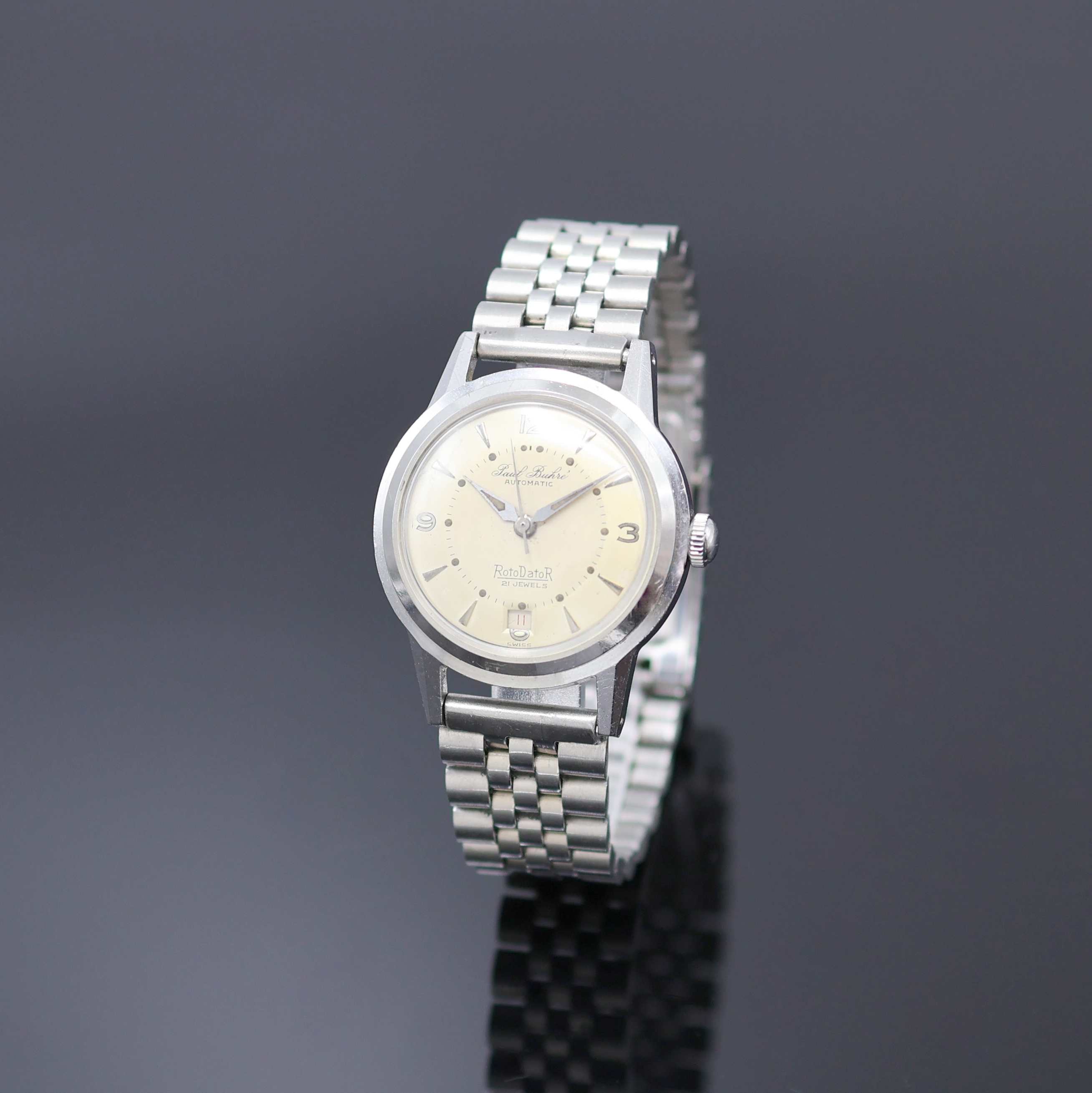 PAUL BUHRE Armbanduhr RotoDatoR, Schweiz um 1957, Automatik, Edelstahlgeh. inkl. neutr. Gliederband, Boden verschr., vers. Zifferbl. m. aufges. ...