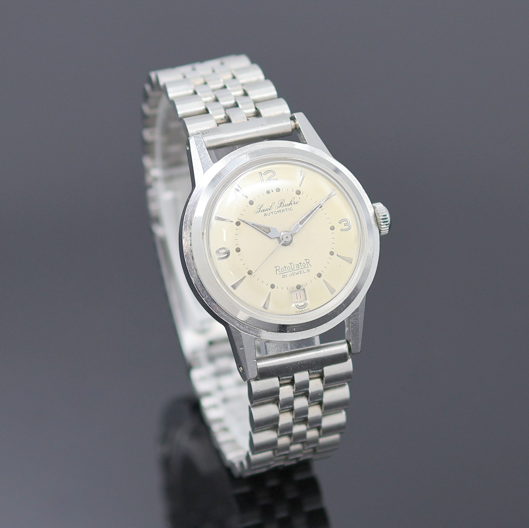 Detail b: PAUL BUHRE Armbanduhr RotoDatoR, Schweiz um 1957, Automatik, Edelstahlgeh. inkl. neutr. Gliederband, Boden verschr., vers. Zifferbl. m. aufges. ...