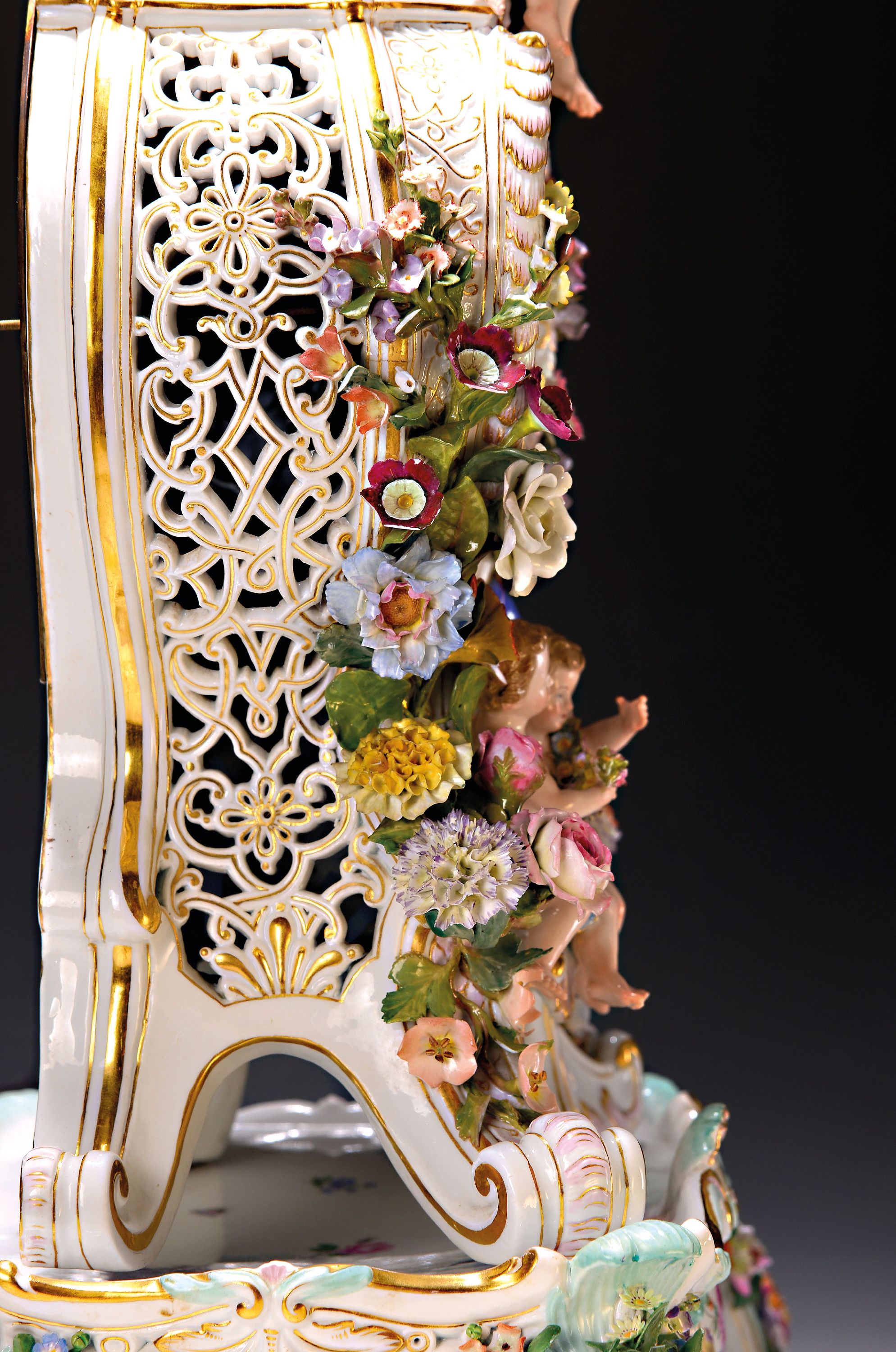 Detail d: Prunkpendule mit Postament, Meissen, um 1880/85, Porzellan, allegorische Darstellung, seitlich mit Durchbrucharbeit, große applizierte Blüten und ...