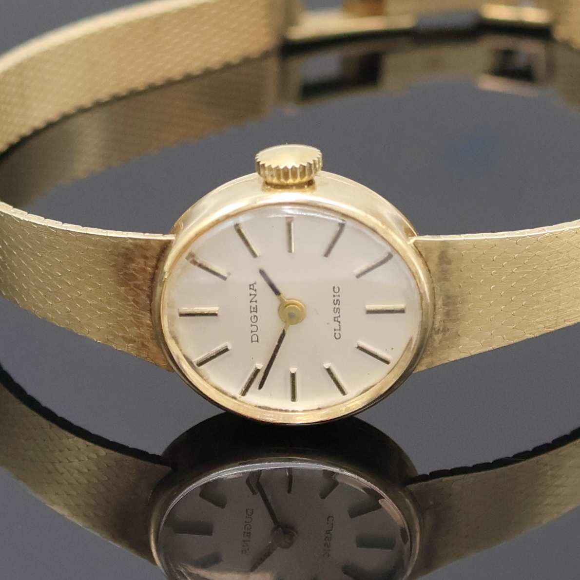 Detail a: DUGENA Classic Damenarmbanduhr in GG 585/000, Schweiz um 1965, Handaufzug, Goldband, Boden aufgedr., silb. Zifferbl. m. aufges. Std.-Ind., geschw. ...