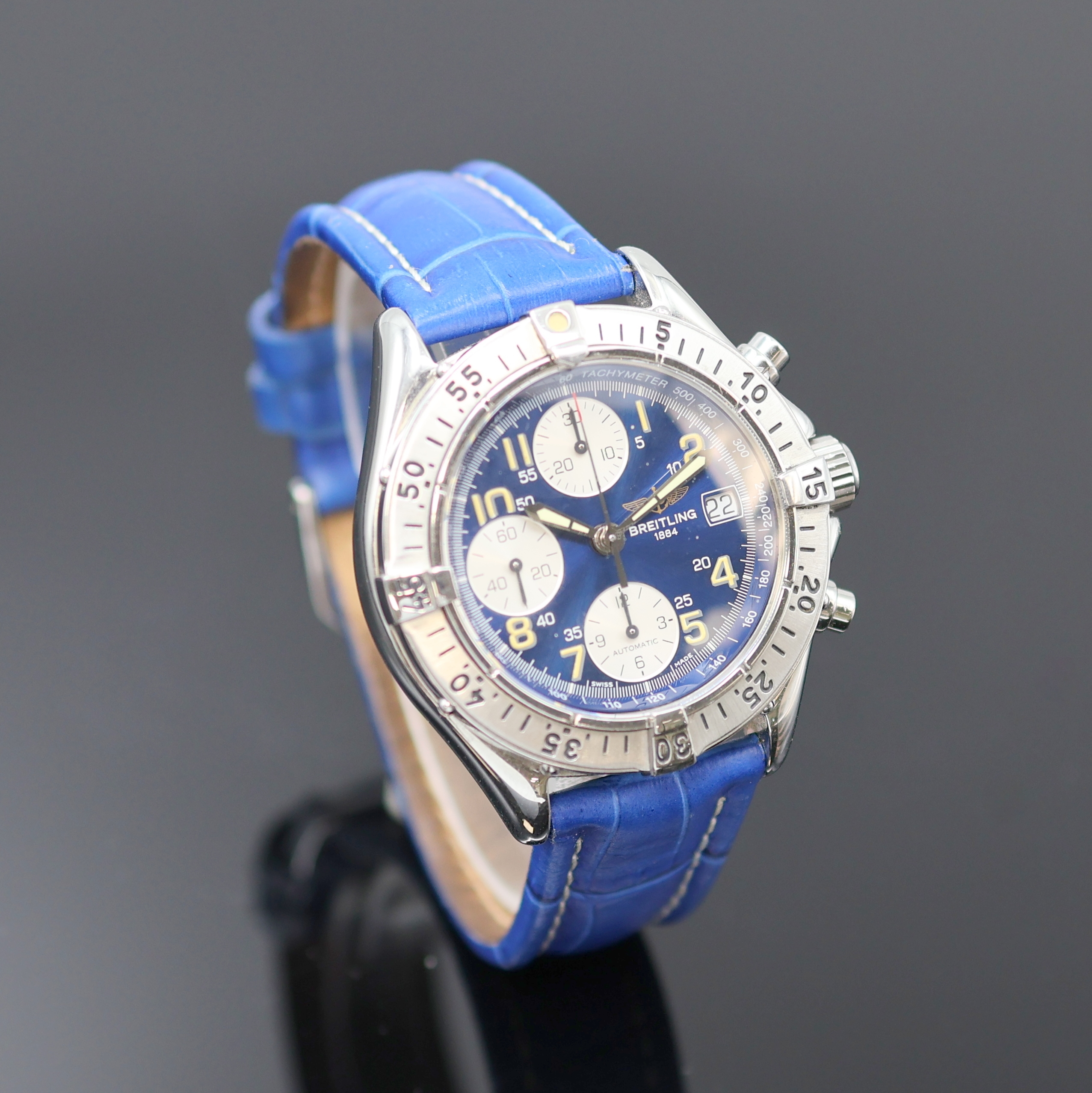 Detail b: BREITLING Armbandchronograph Referenz A13035.1, Schweiz um 1995, Automatik, verschr. Edelstahlgeh., verschr. Krone, eins. drehb. Lünette, blaues ...