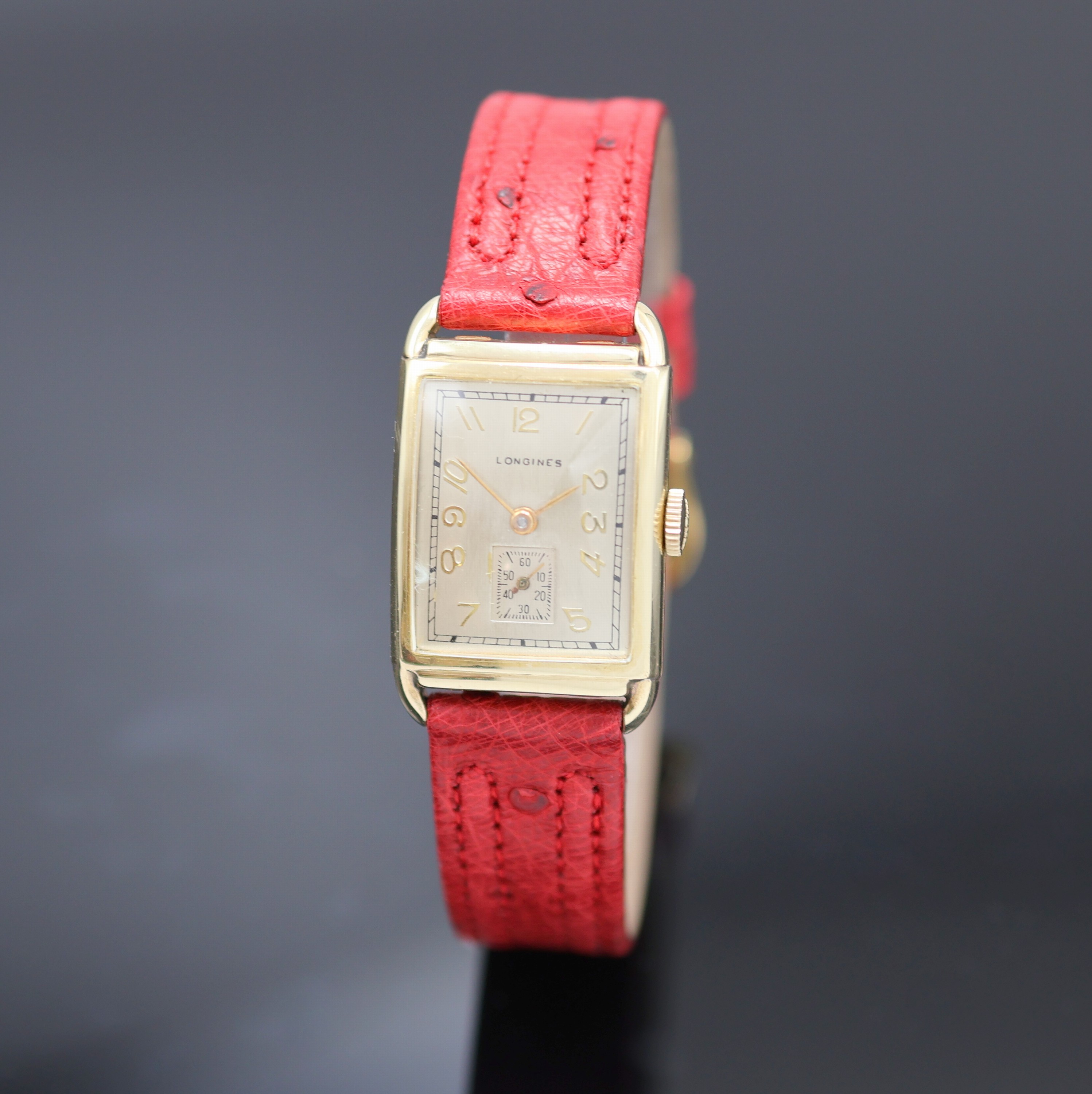 LONGINES rechteckige Armbanduhr in GG 585/000, Schweiz/USA um 1945, Handaufzug, Boden aufgedr., silb. Zifferbl. rest., gold. arab. Zahlen, gold. ...