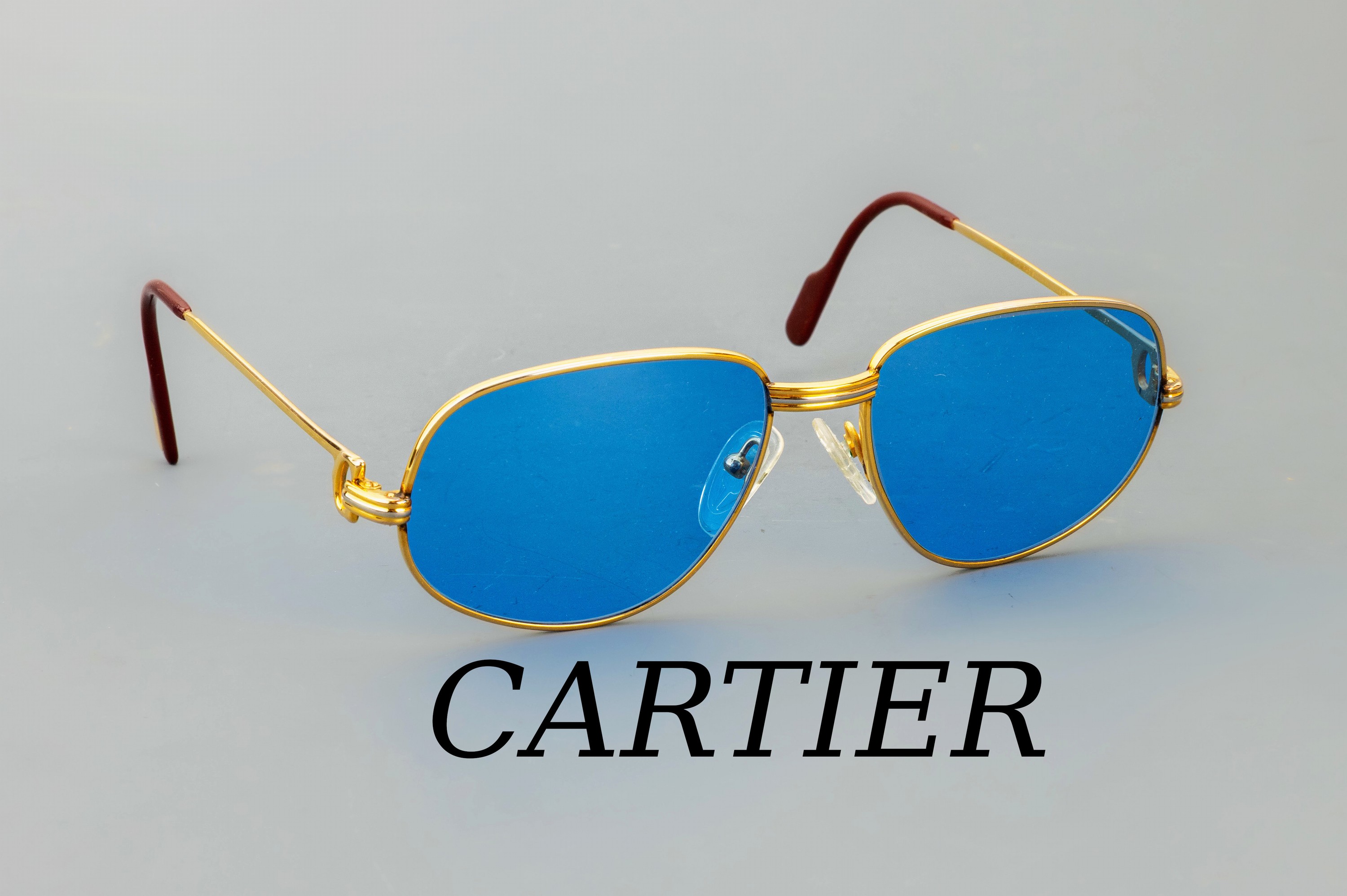 Image 26975438 - CARTIER Sonnenbrille, Trinity, Metall verg., Gr. 130, sign. und num., blau getönte ...