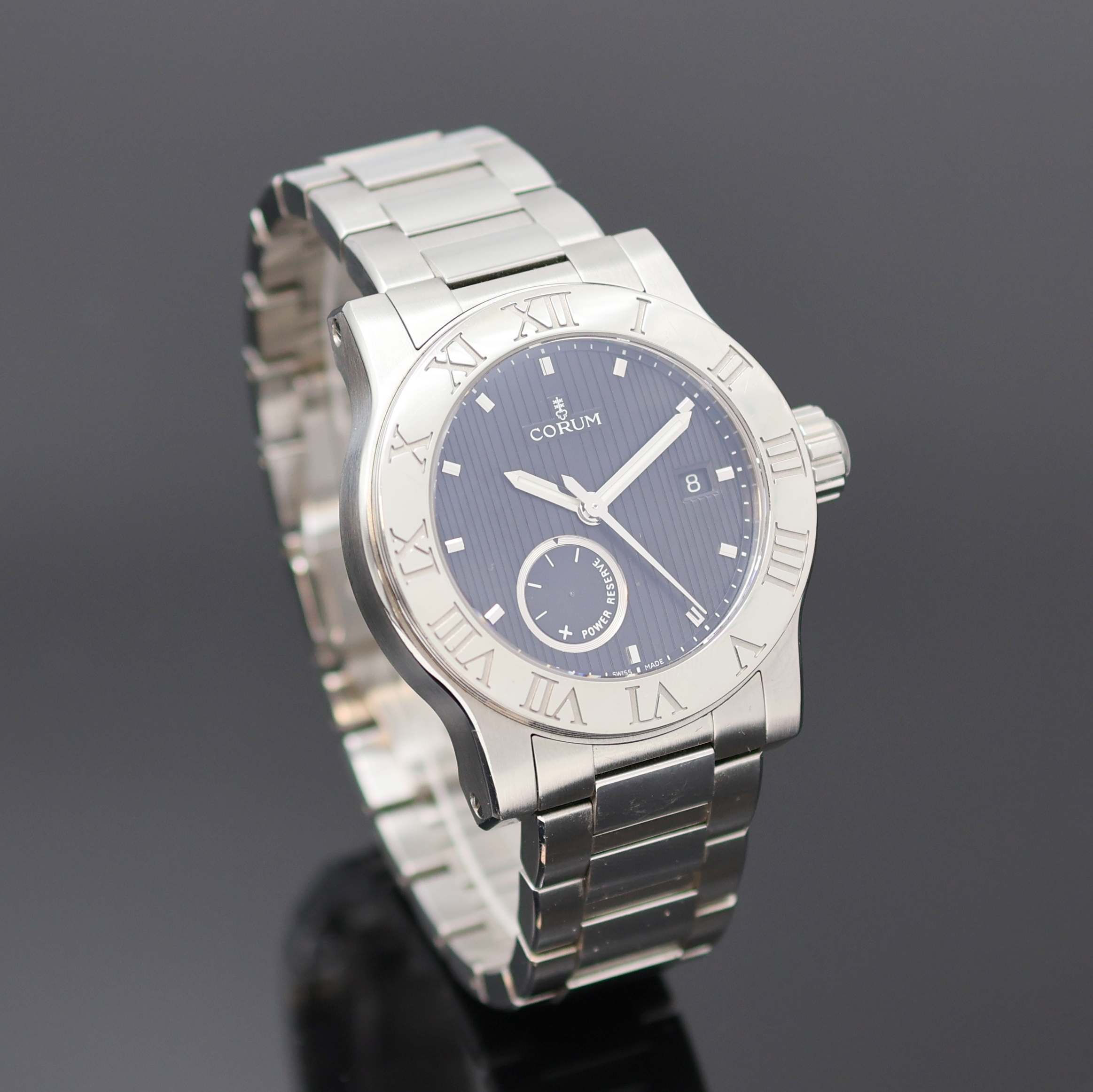 Detail b: CORUM Romulus Herrenarmbanduhr Referenz 02.0001, Schweiz um 2005, Automatik, Edelstahlgeh., Boden u. Krone verschr., orig. Stahlband m. dopp. ...