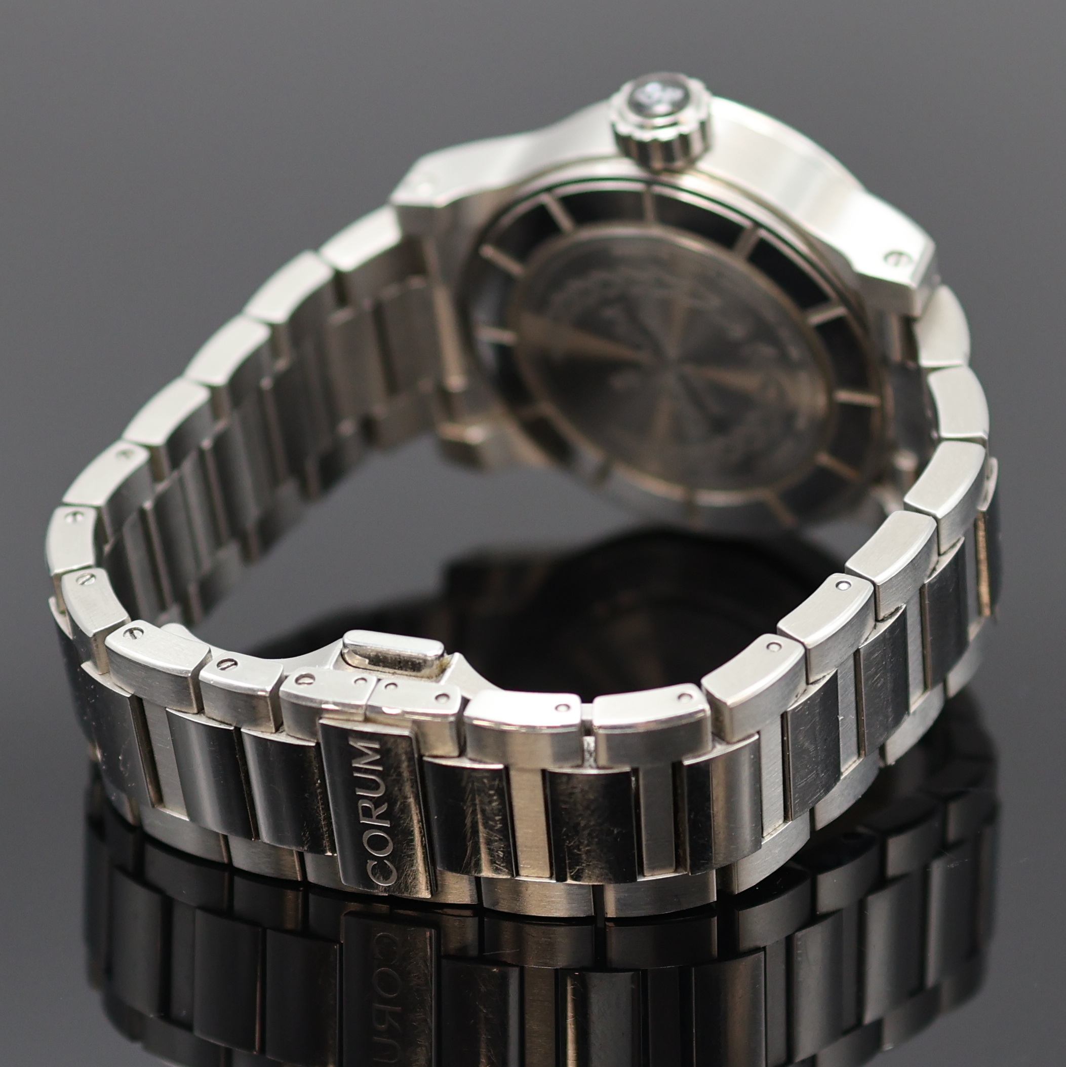 Detail c: CORUM Romulus Herrenarmbanduhr Referenz 02.0001, Schweiz um 2005, Automatik, Edelstahlgeh., Boden u. Krone verschr., orig. Stahlband m. dopp. ...