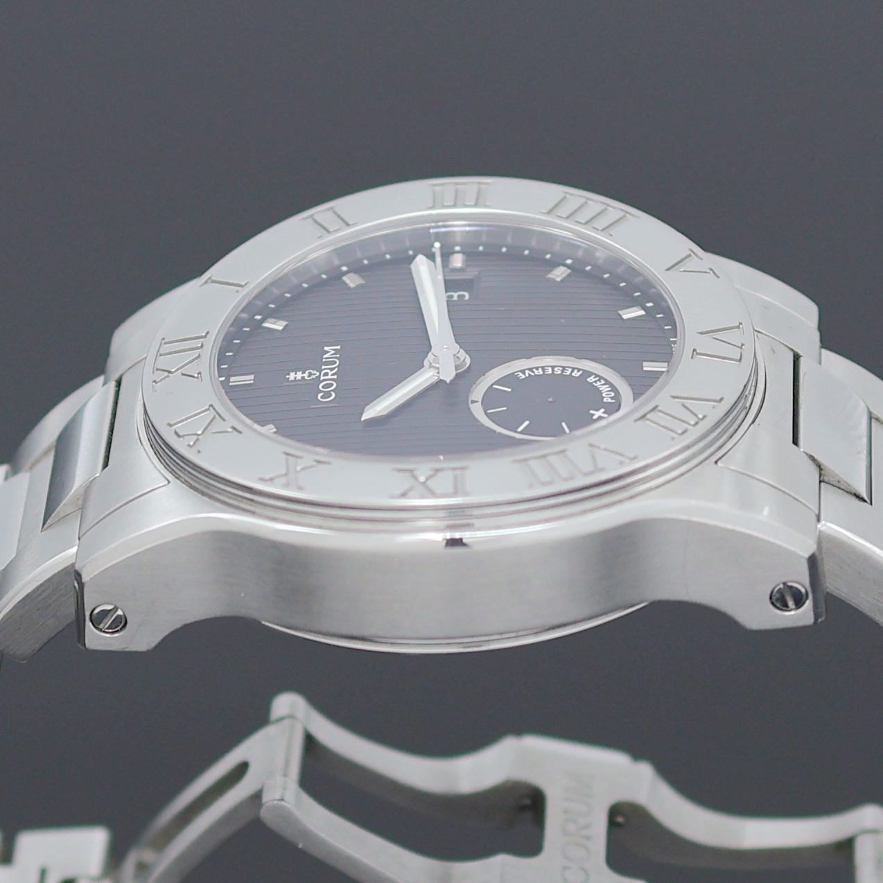 Detail e: CORUM Romulus Herrenarmbanduhr Referenz 02.0001, Schweiz um 2005, Automatik, Edelstahlgeh., Boden u. Krone verschr., orig. Stahlband m. dopp. ...