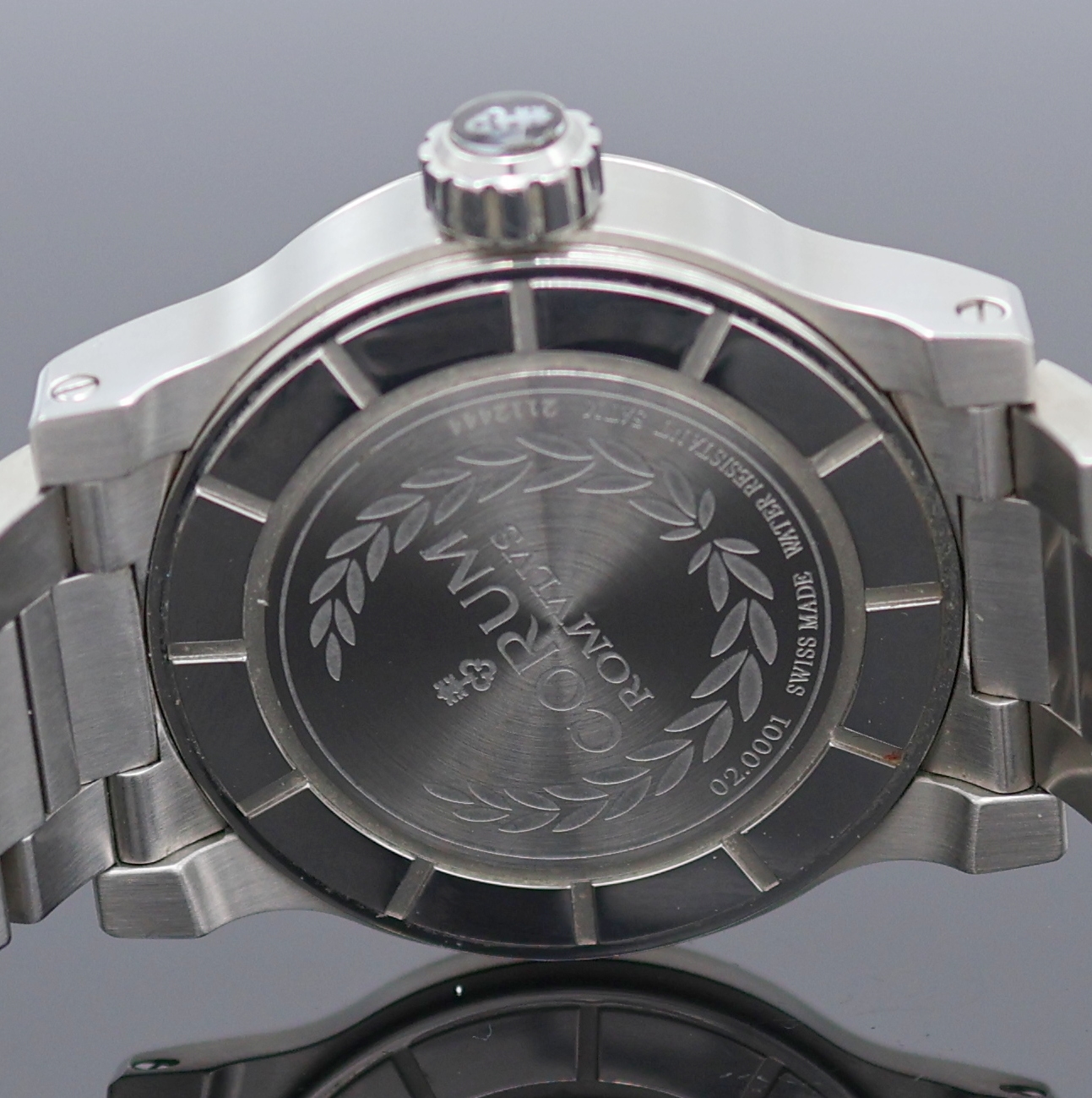 Detail f: CORUM Romulus Herrenarmbanduhr Referenz 02.0001, Schweiz um 2005, Automatik, Edelstahlgeh., Boden u. Krone verschr., orig. Stahlband m. dopp. ...