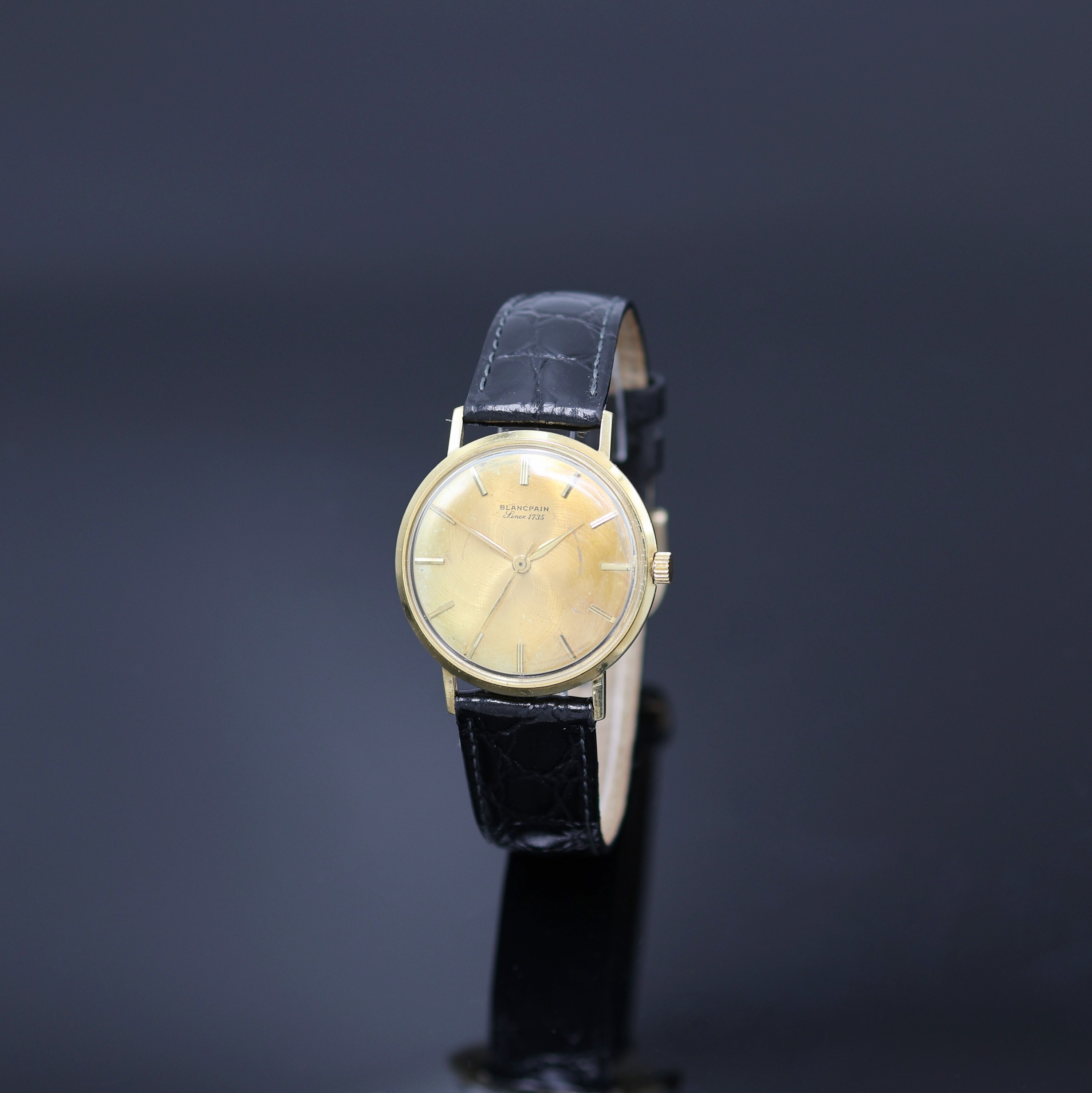 BLANCPAIN Armbanduhr in GG 750/000, Schweiz um 1970, Automatik, Monocoque-Geh., goldfarb. Zifferbl. m. aufges. gold. Std.-Ind. fl., gold. Zeiger, ...